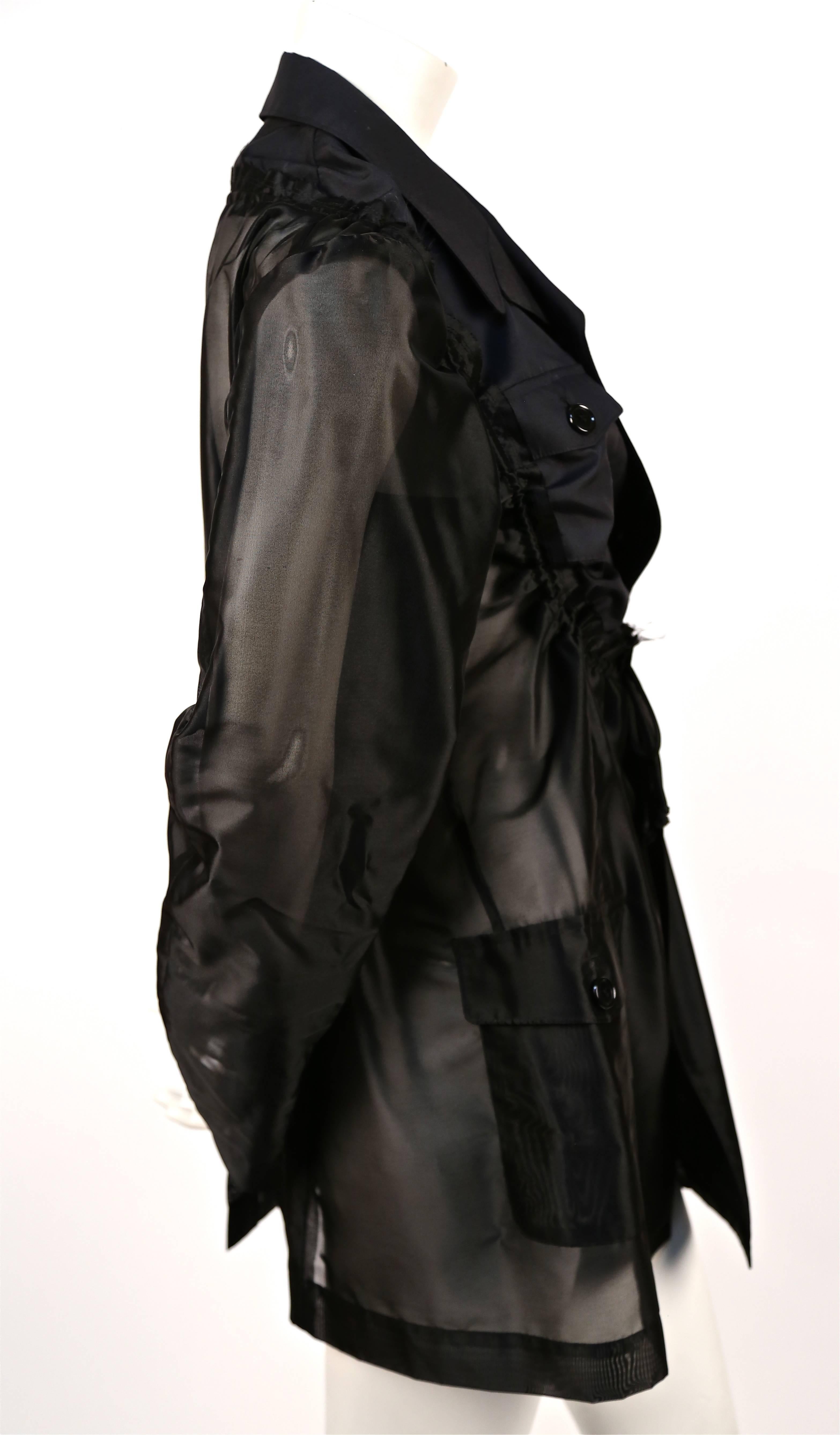 Jet black sheer jacket with adjustable ruched bib from Comme Des Garcons dating to 2002 as seen on the runway. Labeled a size 'M'. Approximate measurement: shoulder 16", bust 35.5", arm length 25" and overall length 30". Button