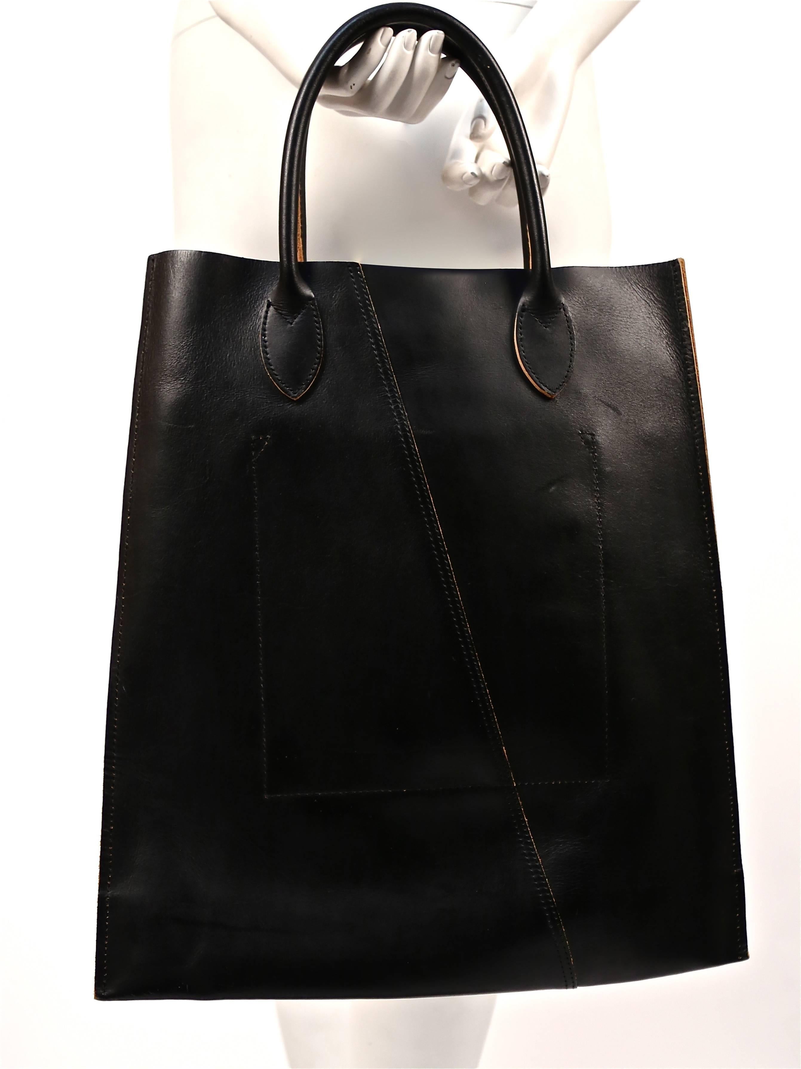Very rare black cowhide leather bag with hand woven saddle stitching details from Comme Des Garcons dating to spring of 2005. Very similar to pieces seen on the runway. Bag measures approximately: 12.5