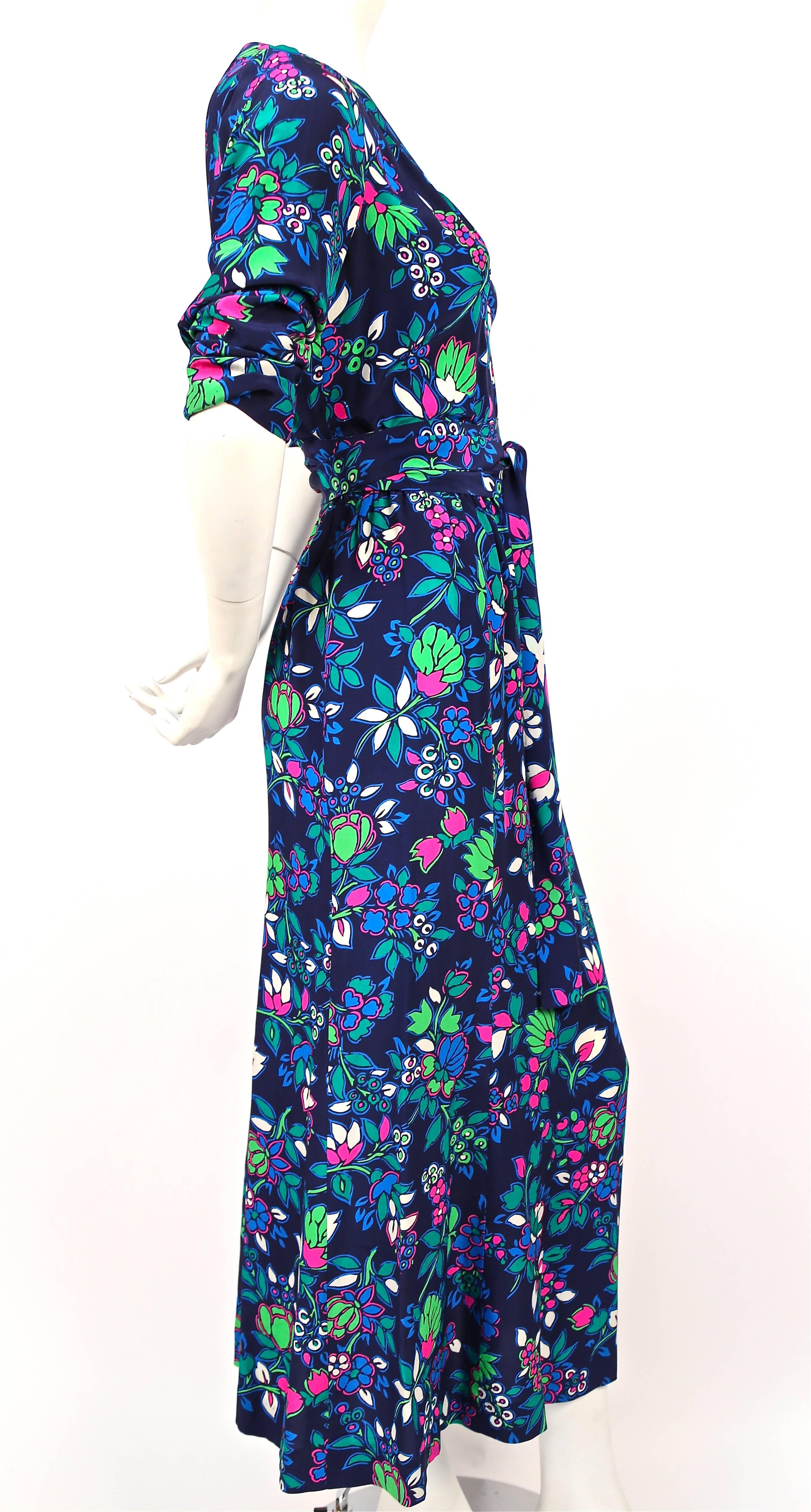 Floral silk dress with long waist tie and v-neckline from Yves Saint Laurent dating to the early 1980's. Labeled a size French size 38 however this better suits a FR 36. Dress measures approximately: bust 34-37