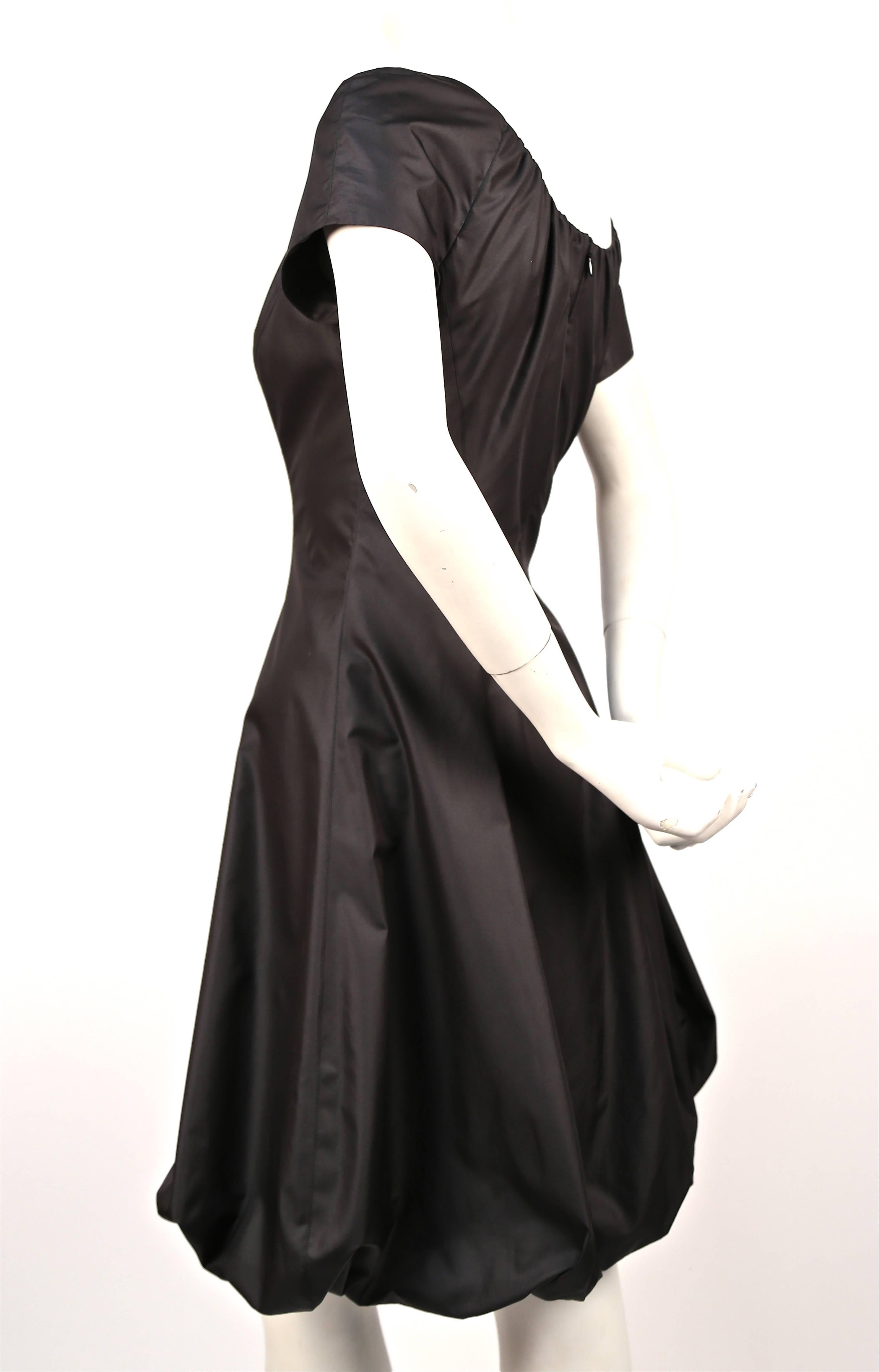 Jet black silk dress with gathered neckline and bubble hemline from Thierry Mugler dating to the 1990's. Labeled French size 38, which best fits a US 4 or 6. Dress measures approximately: 36