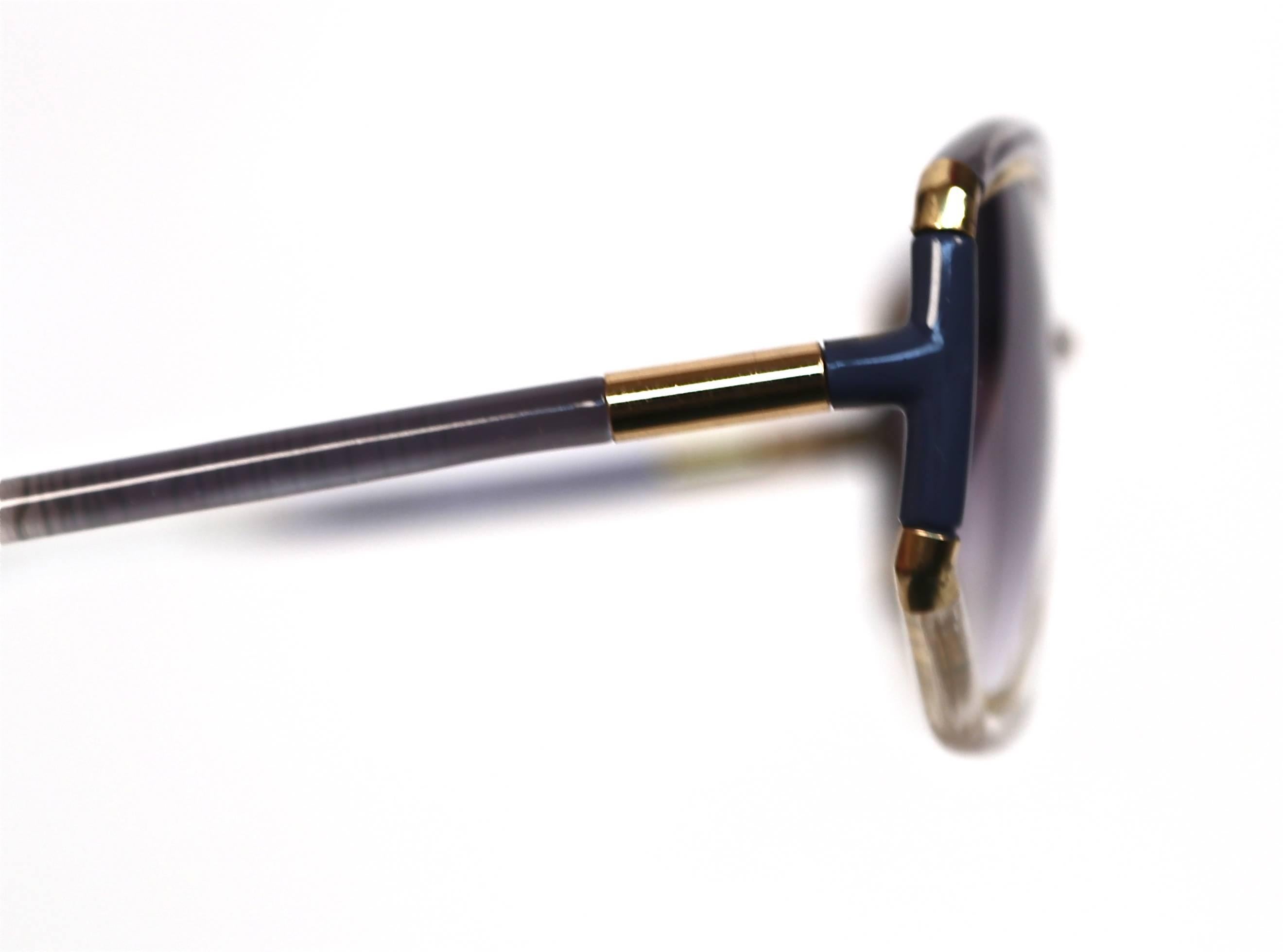 Stunning blue gradient colored plastic sunglasses with gilt metal trim from Ted Lapidus dating to the 1970's. Made in France. Unworn/excellent condition.
