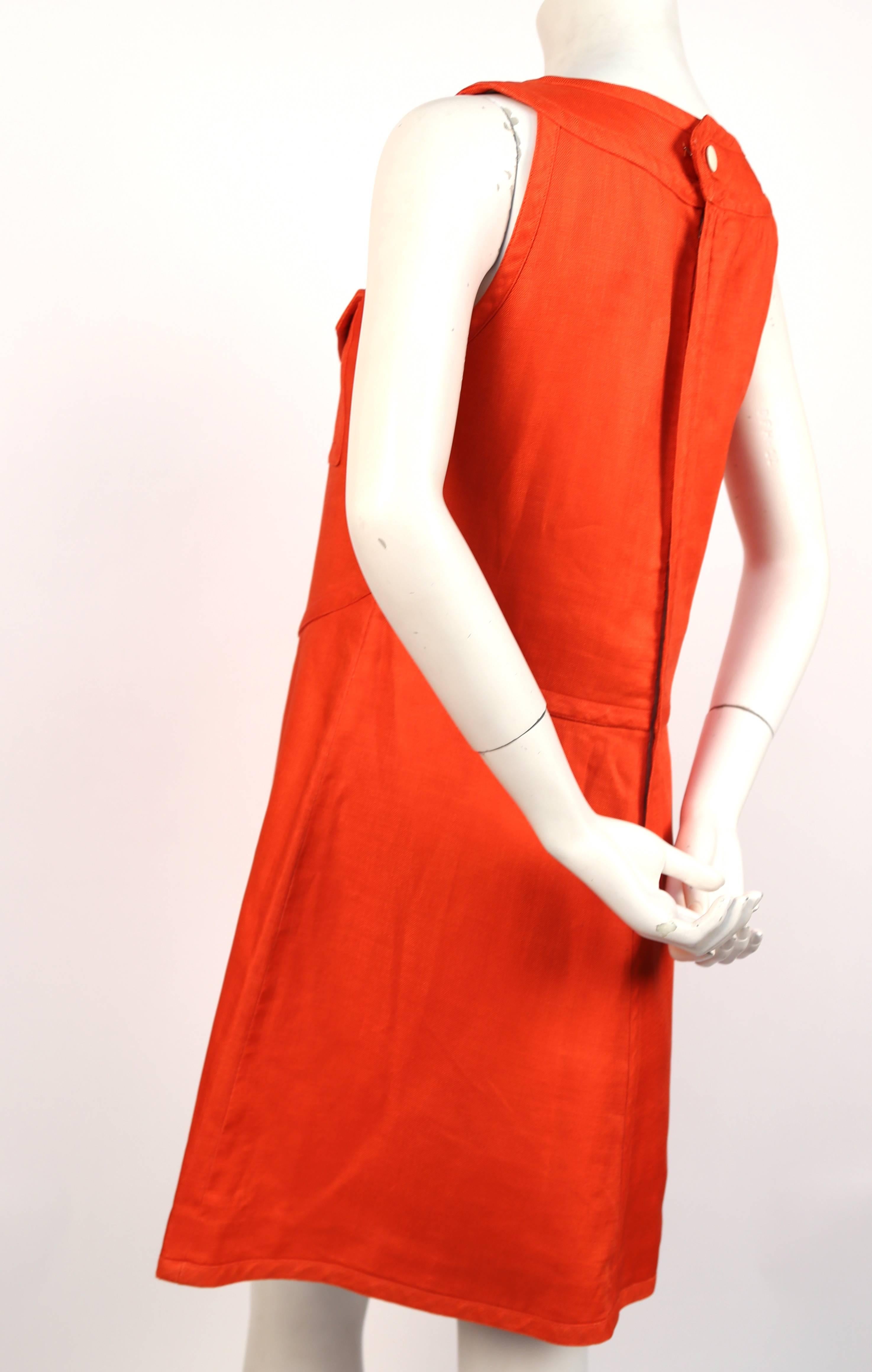 Very rare vivid tangerine linen A-line haute couture dress with patch pockets from Courreges dating to the 1960's. Numbered. Fits a size 6 or 8. Approximate measurements: bust 35-35", waist 34", hips 44" and length 35".  Made in