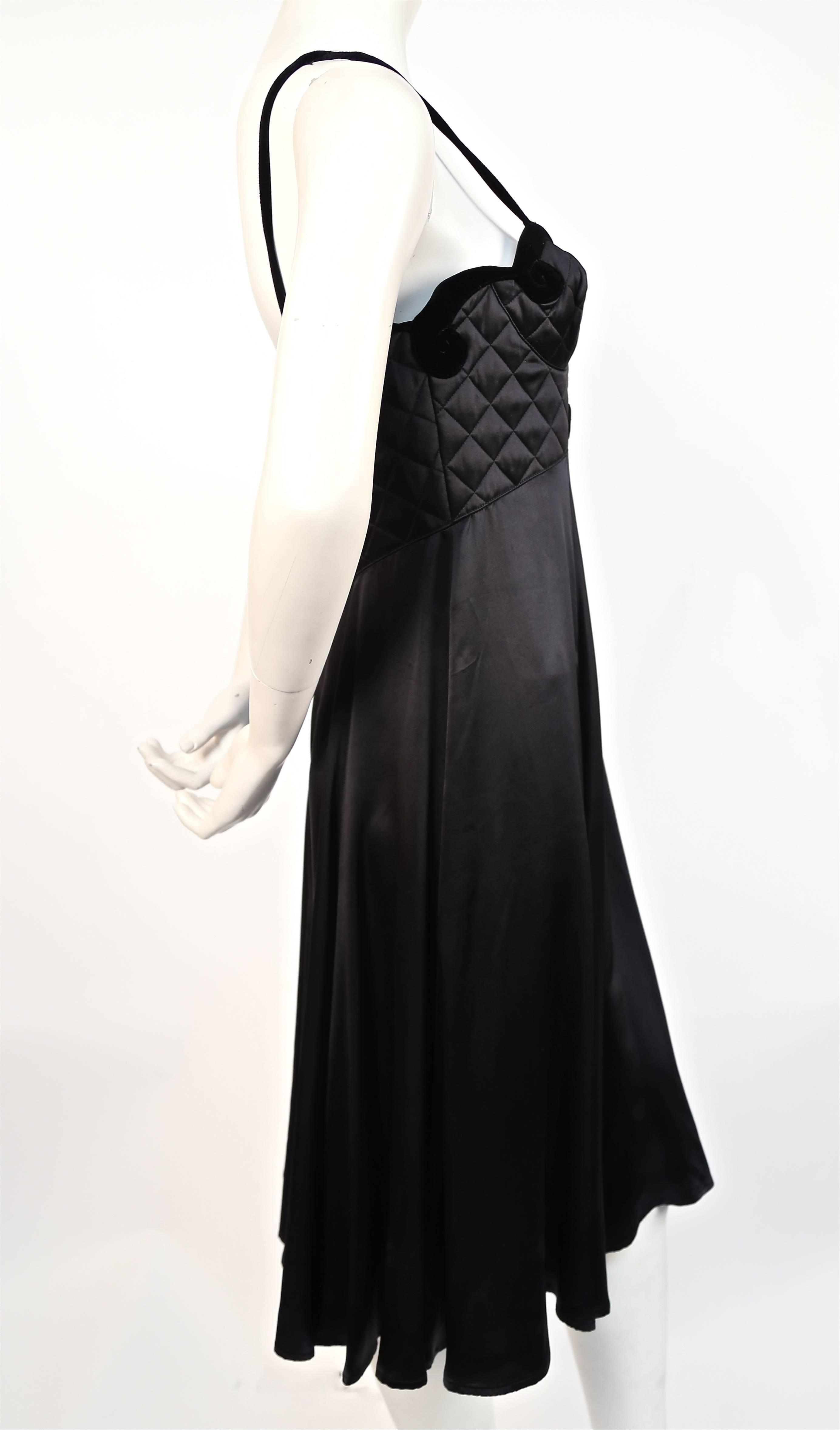 Very rare jet black silk charmeuse gown with quilted vevet bustier by Thierry Mugler dating to circa 1992. Unique cut out at bust.  Best fits a size 6 or slim 8. Approximate measurements *due to internal bustier*: bust 34-35