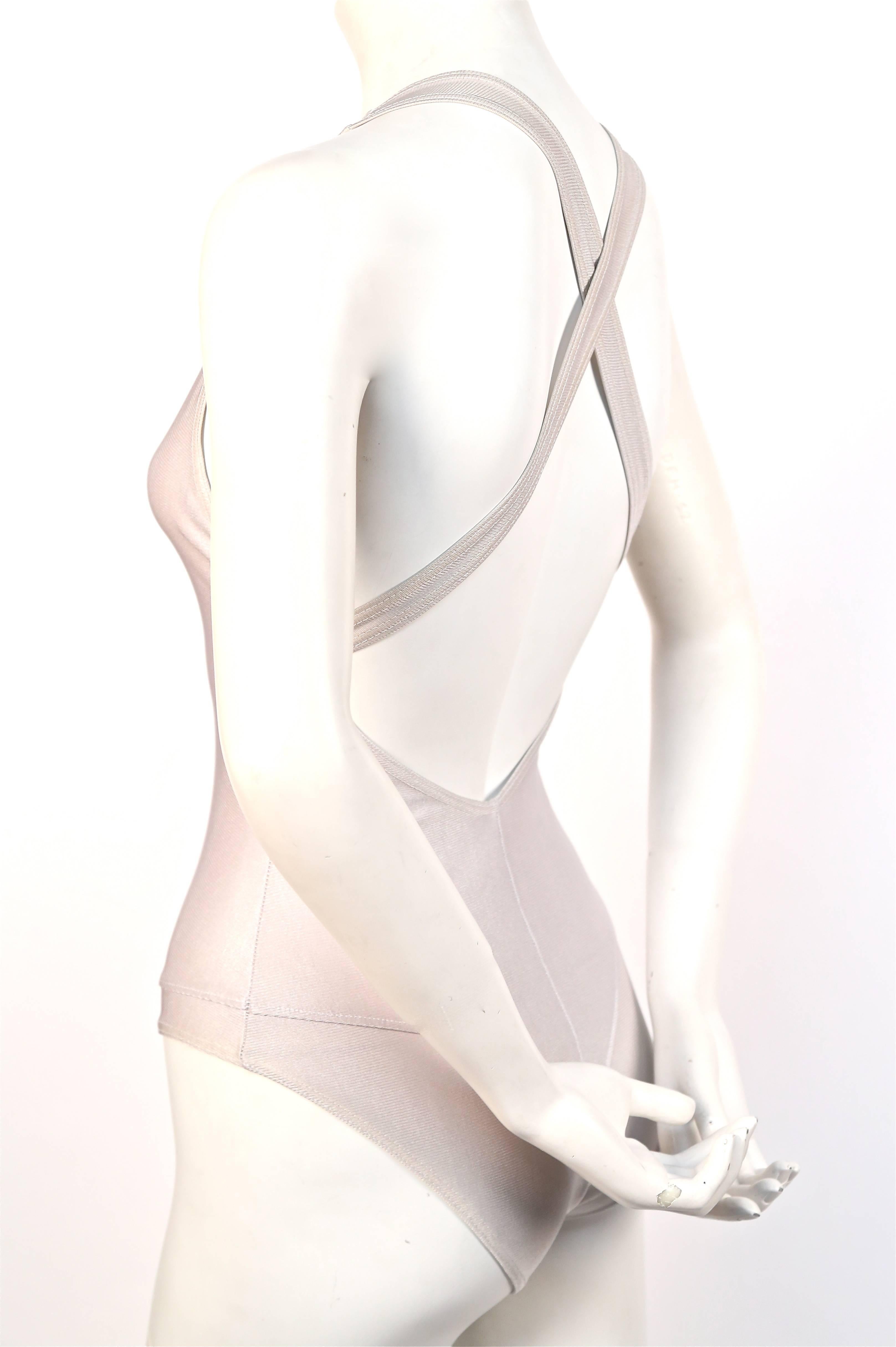 Very rare silver swimsuit with crossed back straps from Azzedine Alaia dating to the 1990's.  Labeled a 'M' (FR 38), however this swimsuit best fits a size S or XS (mannequin measures 32