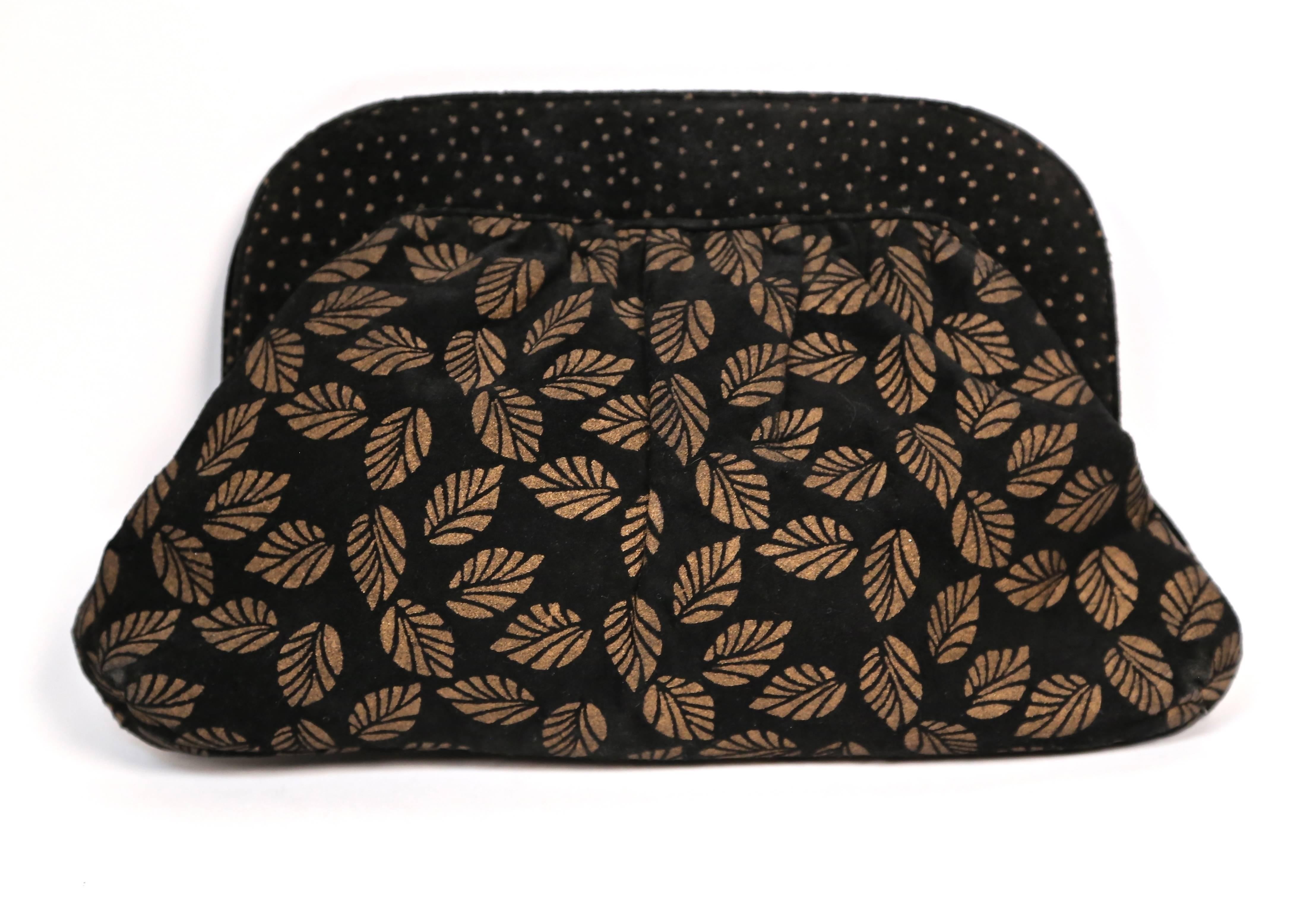 Black and gold suede convertible clutch from Halston dating to the 1970's. Measures approximately: 11