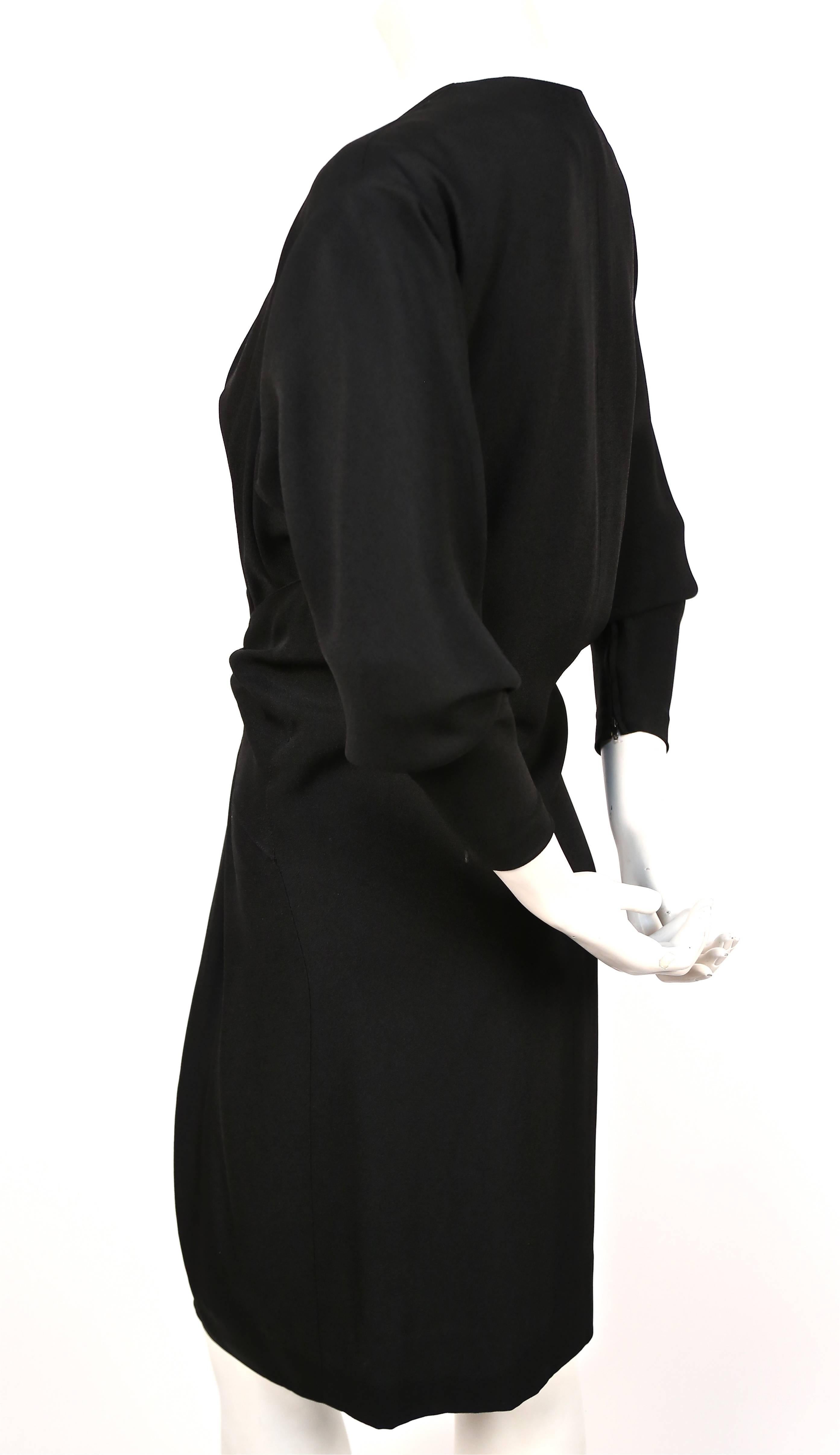 Black crepe dress with plunging neckline and draped waist from Yves Saint Laurent dating to the late 1970's.  Exact dress as seen on Julia Roberts at the 2010 Golden Globe awards. Dress best fits a size 6. Bust measures approximately: shoulder 16