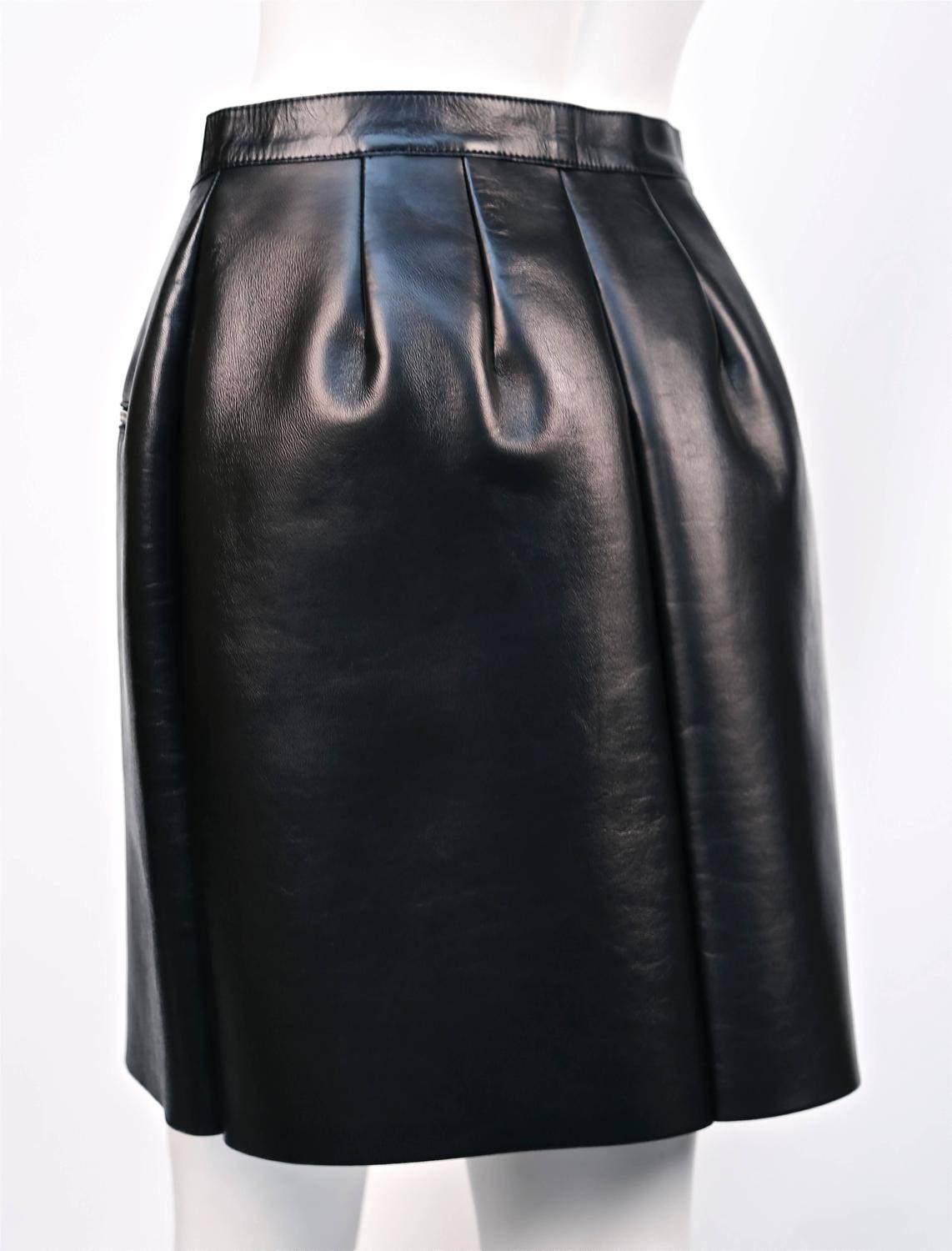 Jet black smooth leather skirt with silver zipper details designed by Phoebe Philo for Celine. French size 38. Approximate measurements: waist 29”, Hip 38”, Length 19”.  Zipper at center front with snap closure at waist. Made in Italy. New with
