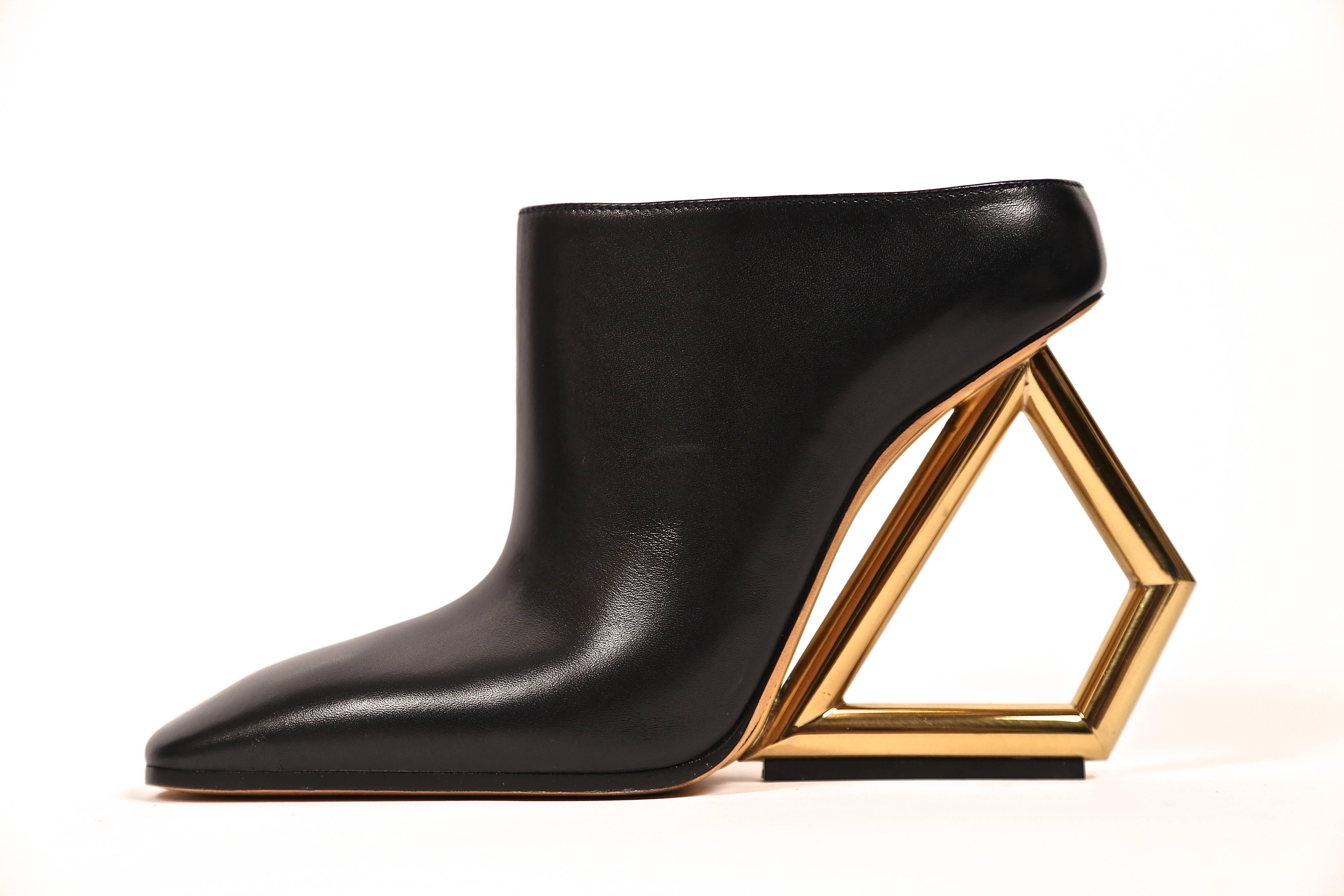 Unworn, black leather mules with gold toned trapezoid heels from Celine as seen on the runway in spring of 2014. French size 39. Insoles measure approximately just under 10.5