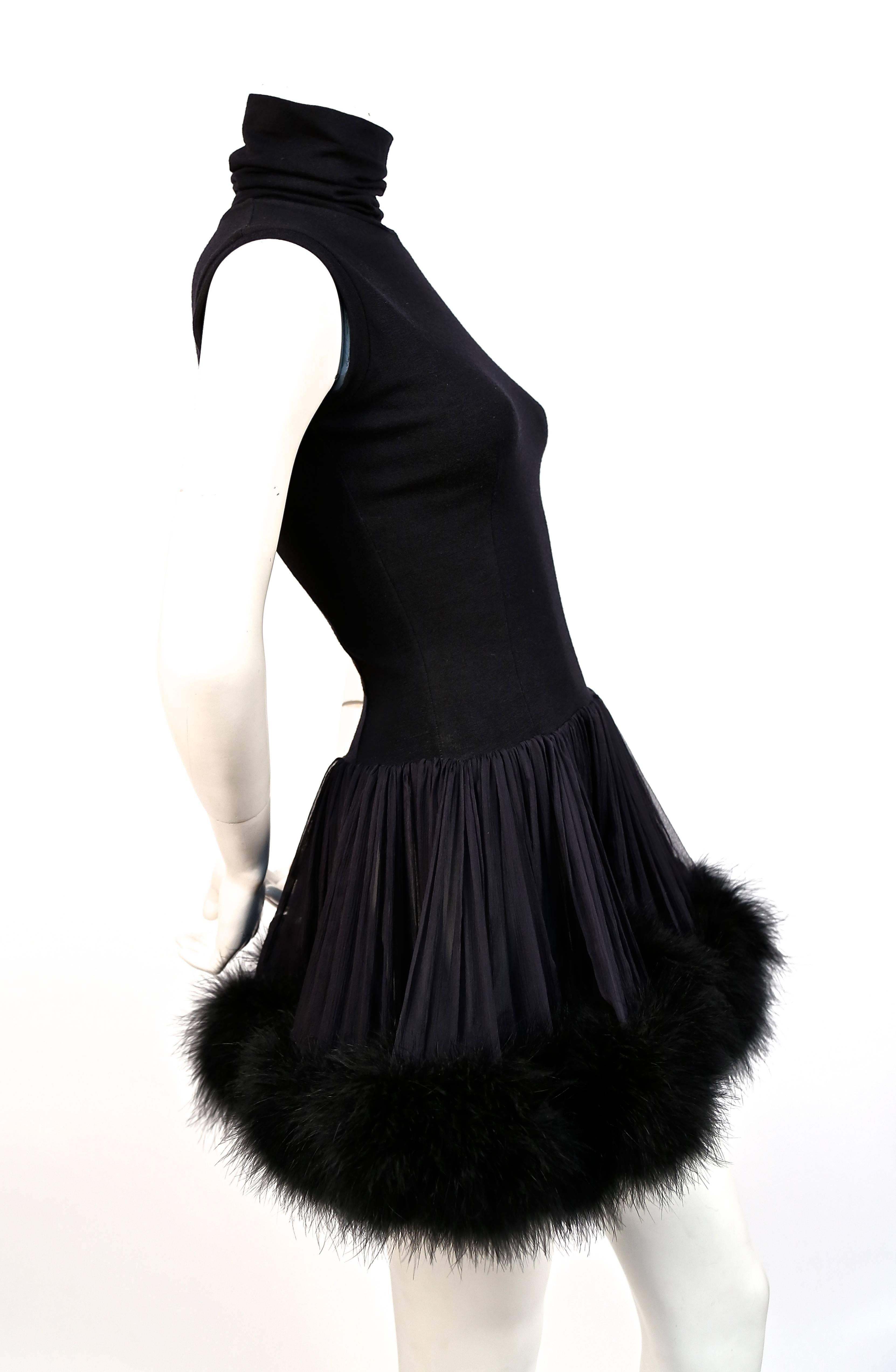 Black wool mini dress with silk and marabou feather trim designed by Dolce & Gabbana dating to the 1980's. Labeled an Italian size 42 however this would best fit a US 2 or 4. Approximate measurements: shoulder 14