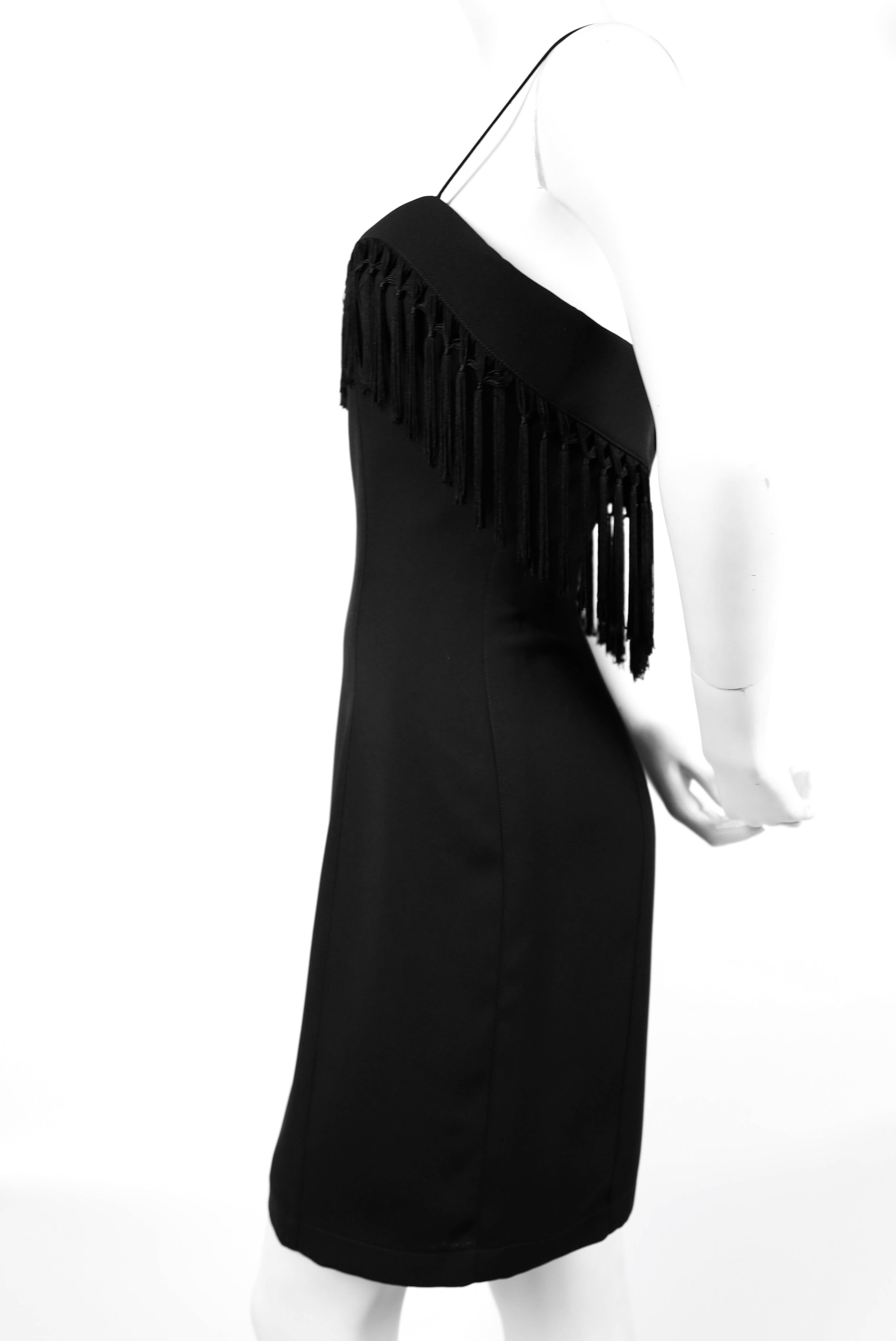 Jet black fitted dress with dramatic fringed trim from Thierry Mugler dating to the early 1990's. Labeled a French size 38. Bust 32.5-33, waist 27', hips 36" and length 35". Hidden back zipper. Made in France. Excellent condition.
