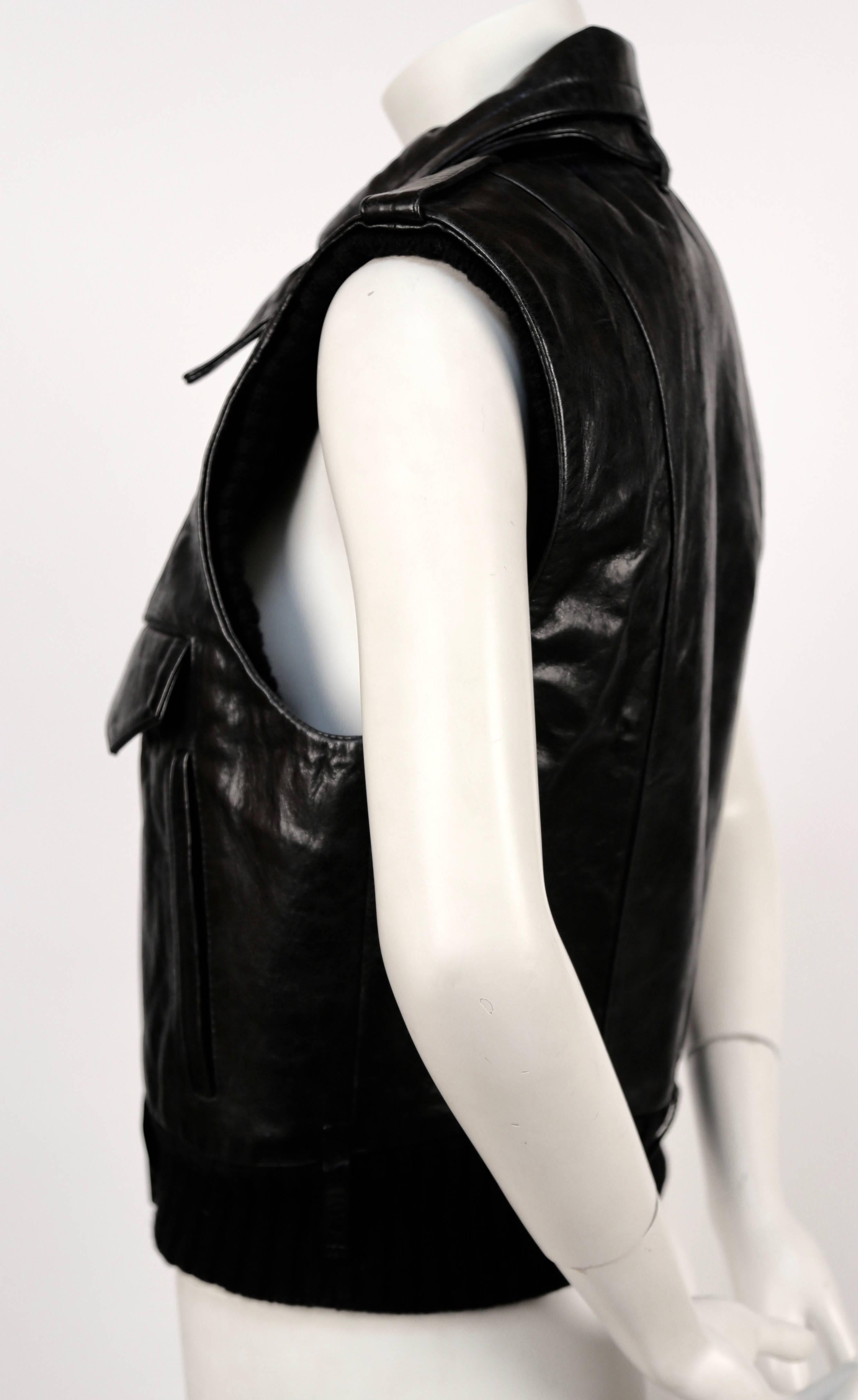 Very rare documented leather vest with wool trim designed by Nicolas Ghesquière for Balenciaga as seen on the runway for fall of 2002. Labeled a French size 40. Approximate measurements: shoulder 15