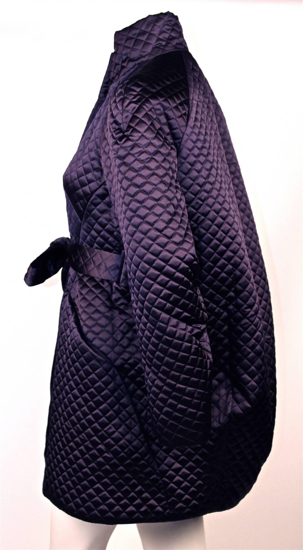 Very rare purple satin quilted cocoon coat with belt from Alexander McQueen as seen on the runway for fall of 2007. Labeled a size 42 however this coat is meant to fit oversized and can be adjusted at the waist with the belt. It best fits a US 4-8.