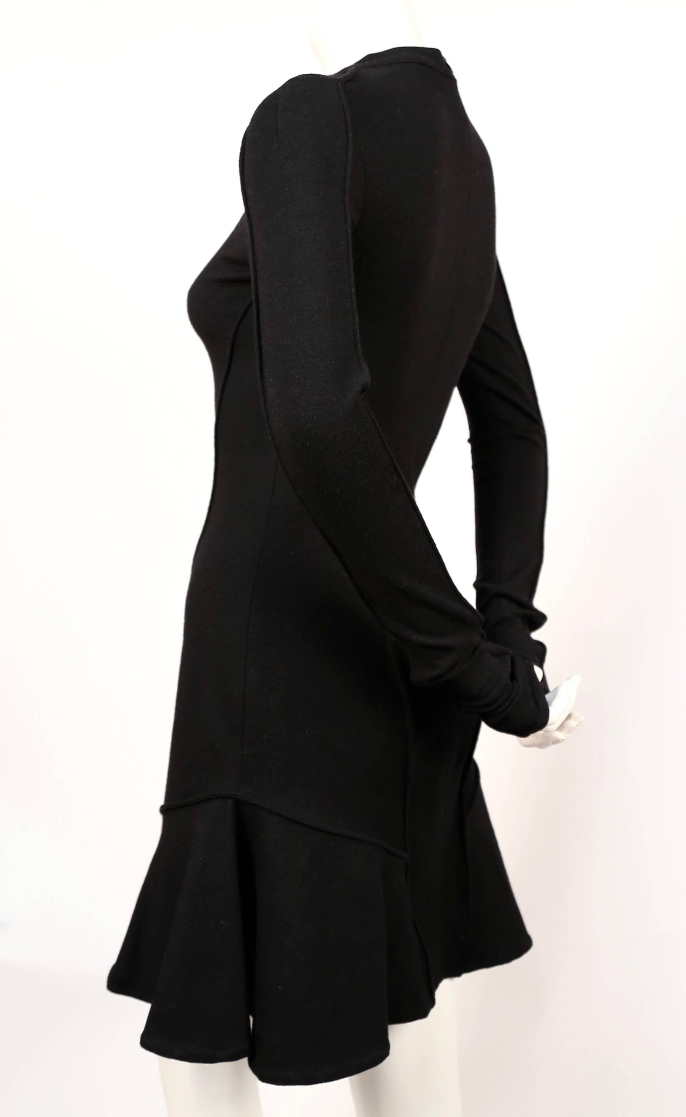 Black wool scuba style dress with flared skirt designed by Nicolas Ghesquiere for Balenciaga dating to fall of 2002. Beautiful seamed detail. Labeled a French size 40. Approximate measurements: bust 32