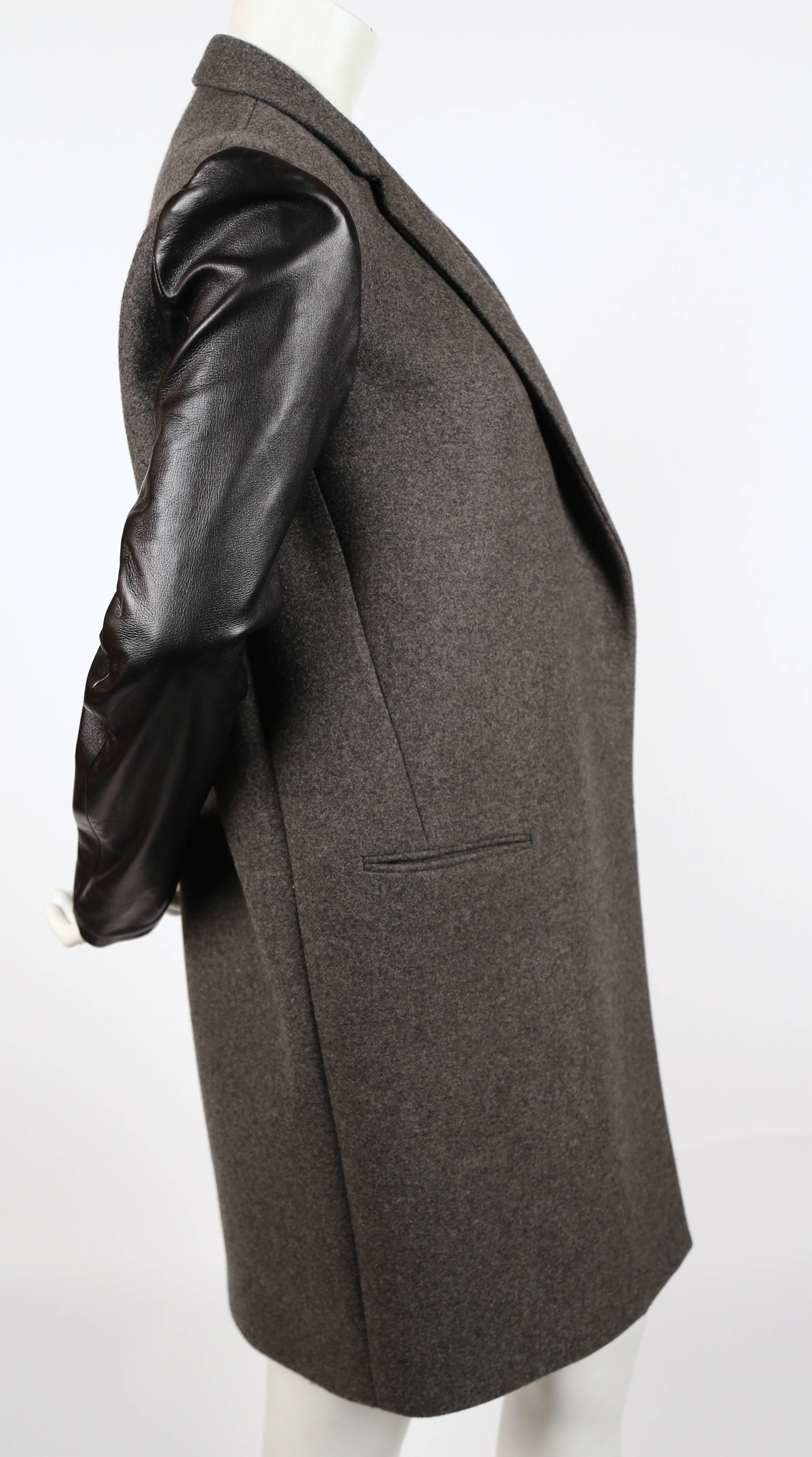 Charcoal grey crombie coat with black lambskin leather sleeves designed by Phoebe Philo for Celine. Labeled a French size 36 which best fits a size XS or S. Approximate measurements: shoulder 15.5