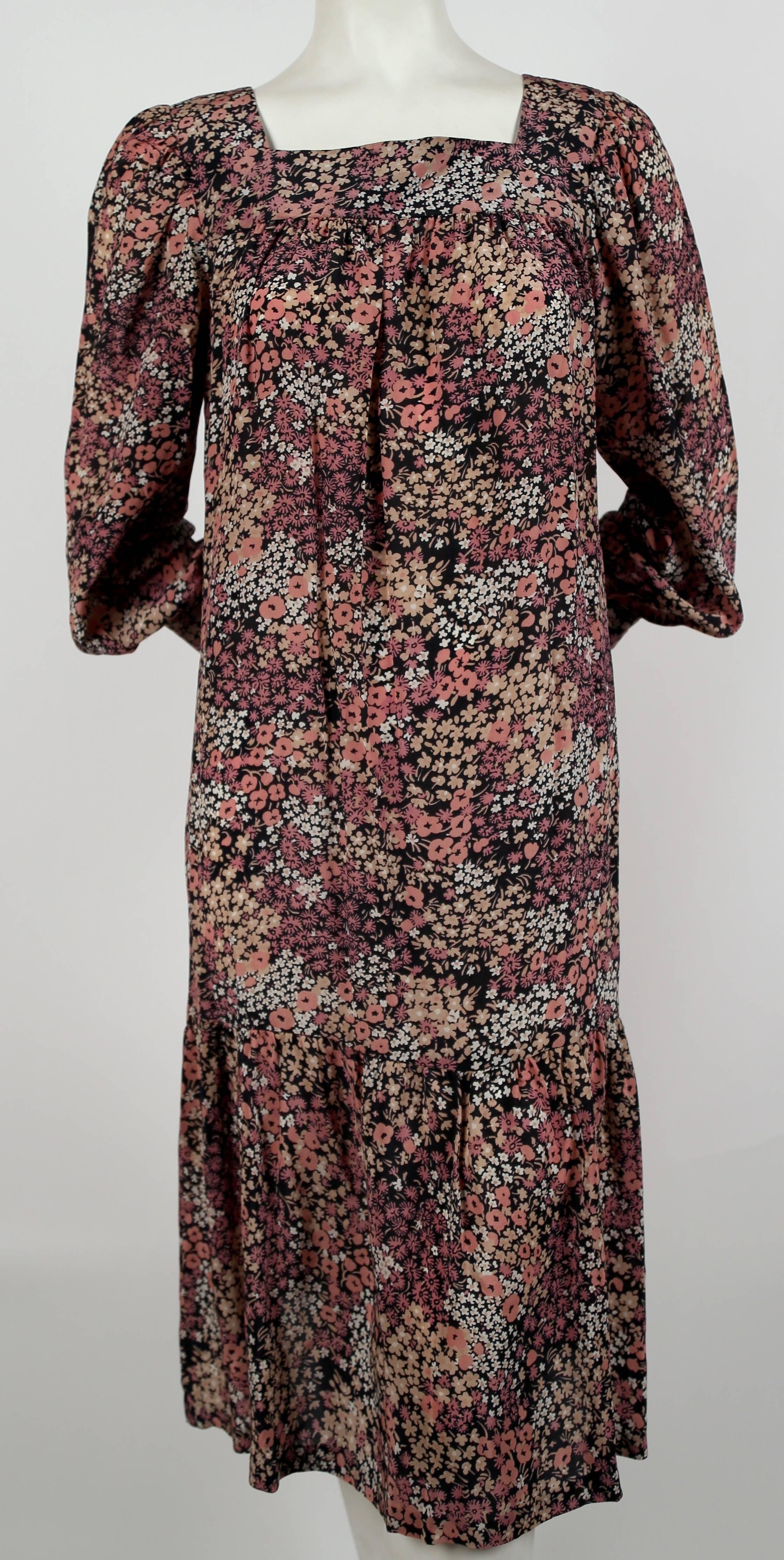 Floral printed silk peasant dress designed by Saint Laurent dating to the 1970's. French size 36. Approximate measurements: shoulder 13.5", bust up to 40", hips up to 42", arm length 24.5" and overall length 42". Button