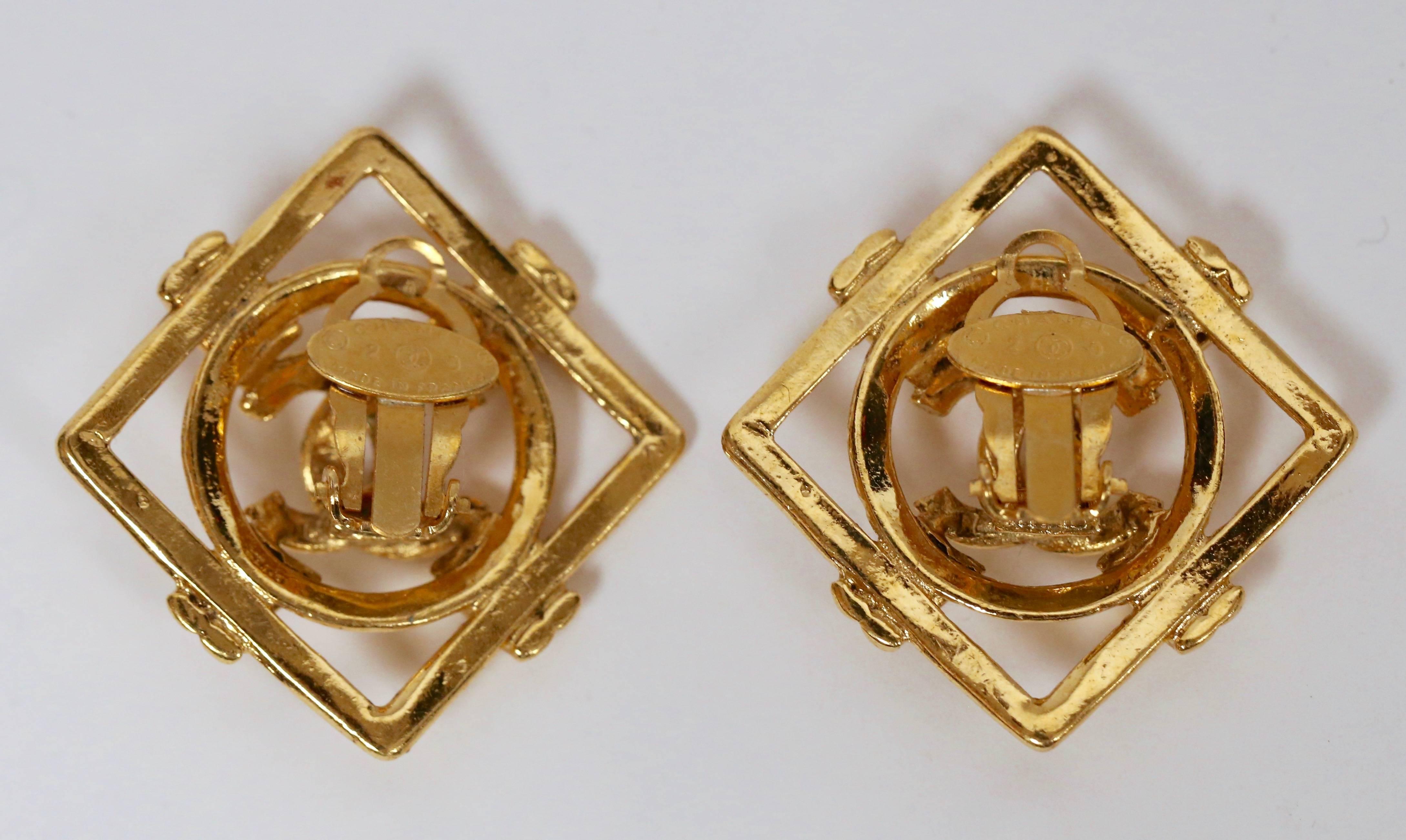 Classic, shiny gilt earrings with interlocking CCs from Chanel dating to 1995. Measurements: just under 1.75" wide by 1.75" tall. Clip backs. Made in France. Very good condition.