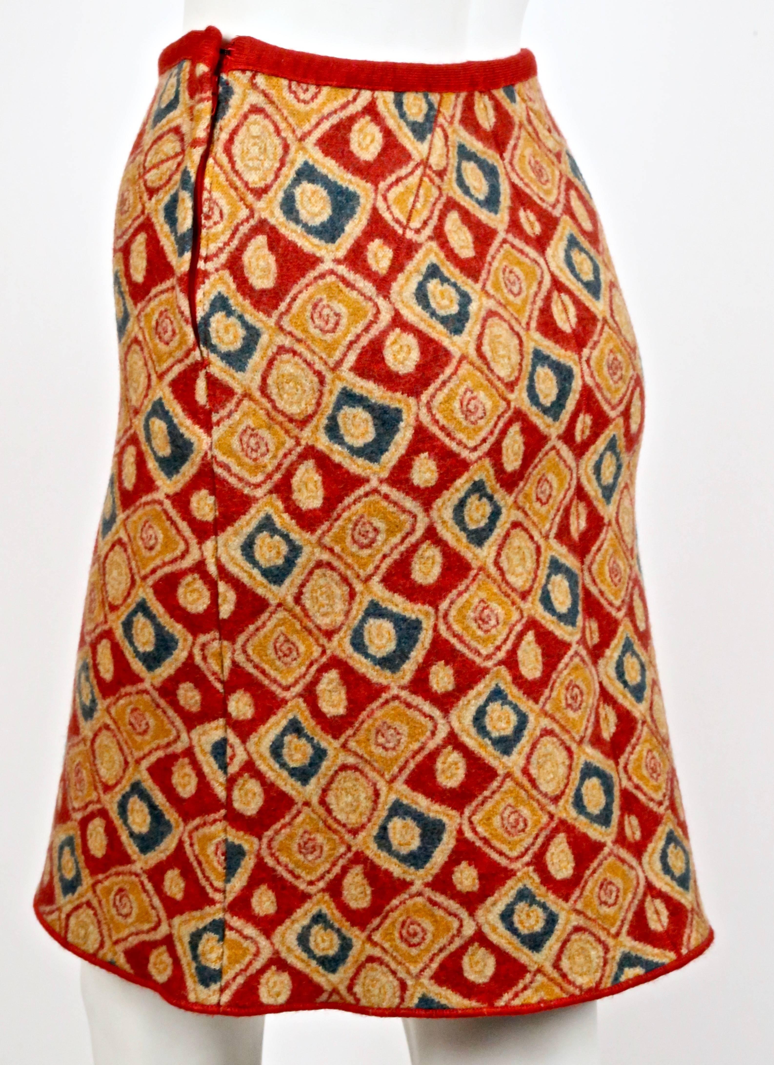 Red abstract patterned boiled wool skirt designed by Azzedine Alaia dating to the 1990's. Fits like an XS or S. Approximate unstretched measurements: waist 25