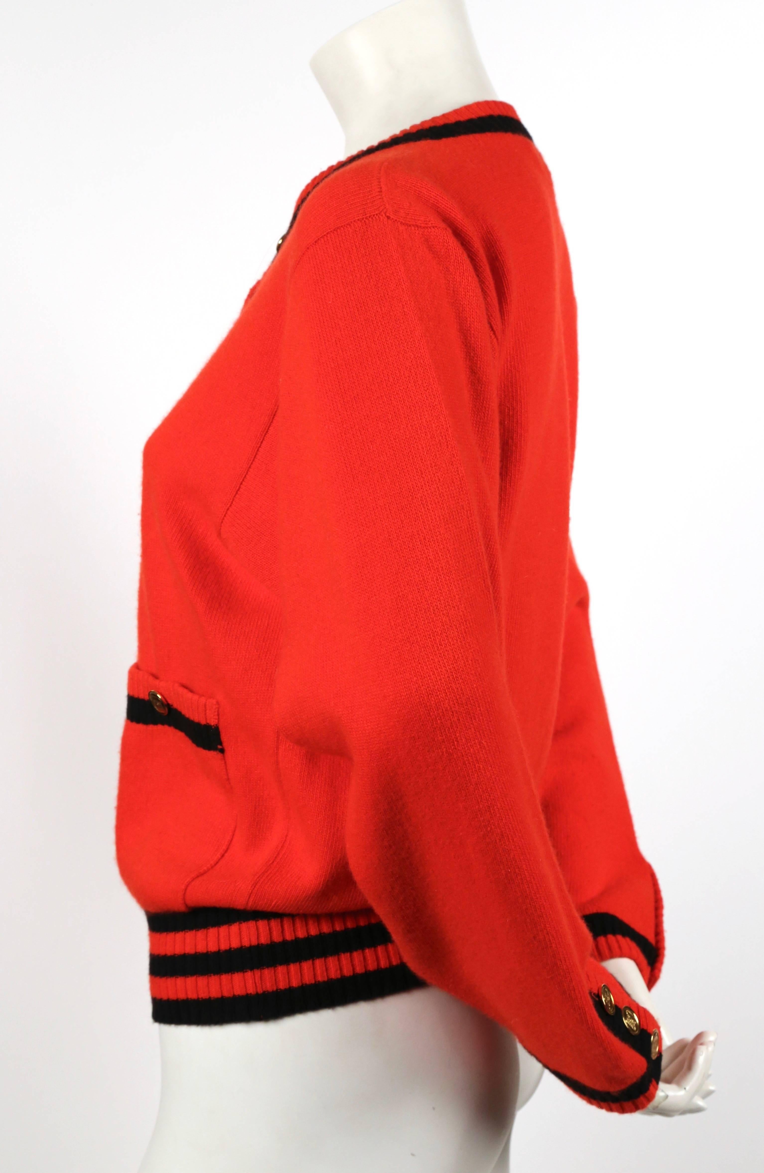 Classic red and black cashmere cardigan with ribbed striped trip and gilt buttons from Chanel dating to the 1980's. Labeled a size S. Approximate measurements: shoulder 16