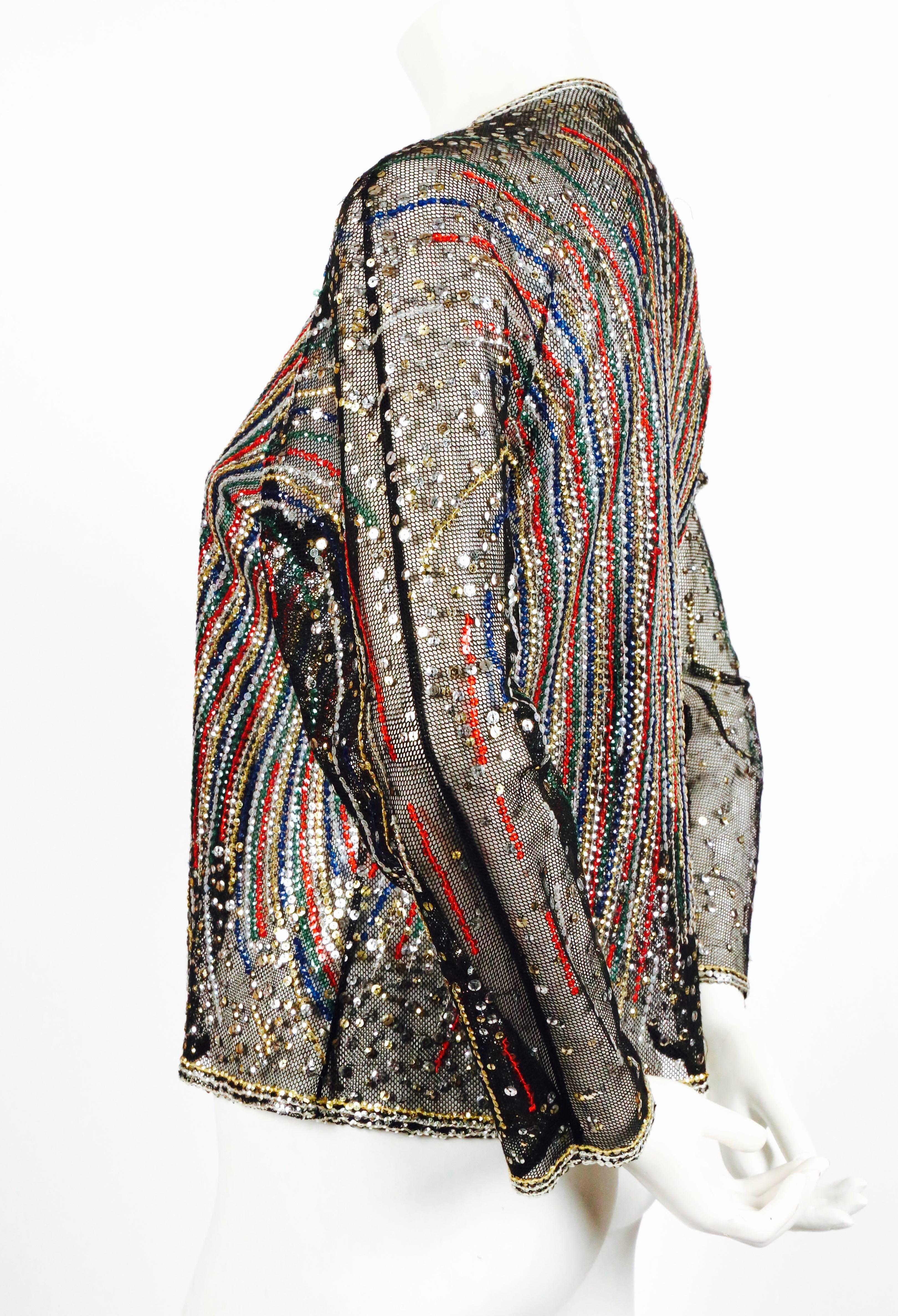 Spectacular jacket made of black tulle artfully decorated with varying sizes of sequins from Halston dating to the 1970's. Sequin colors are gold, silver, ruby red, sapphire blue, emerald green, and iridescent white. Very flexible in sizing due to