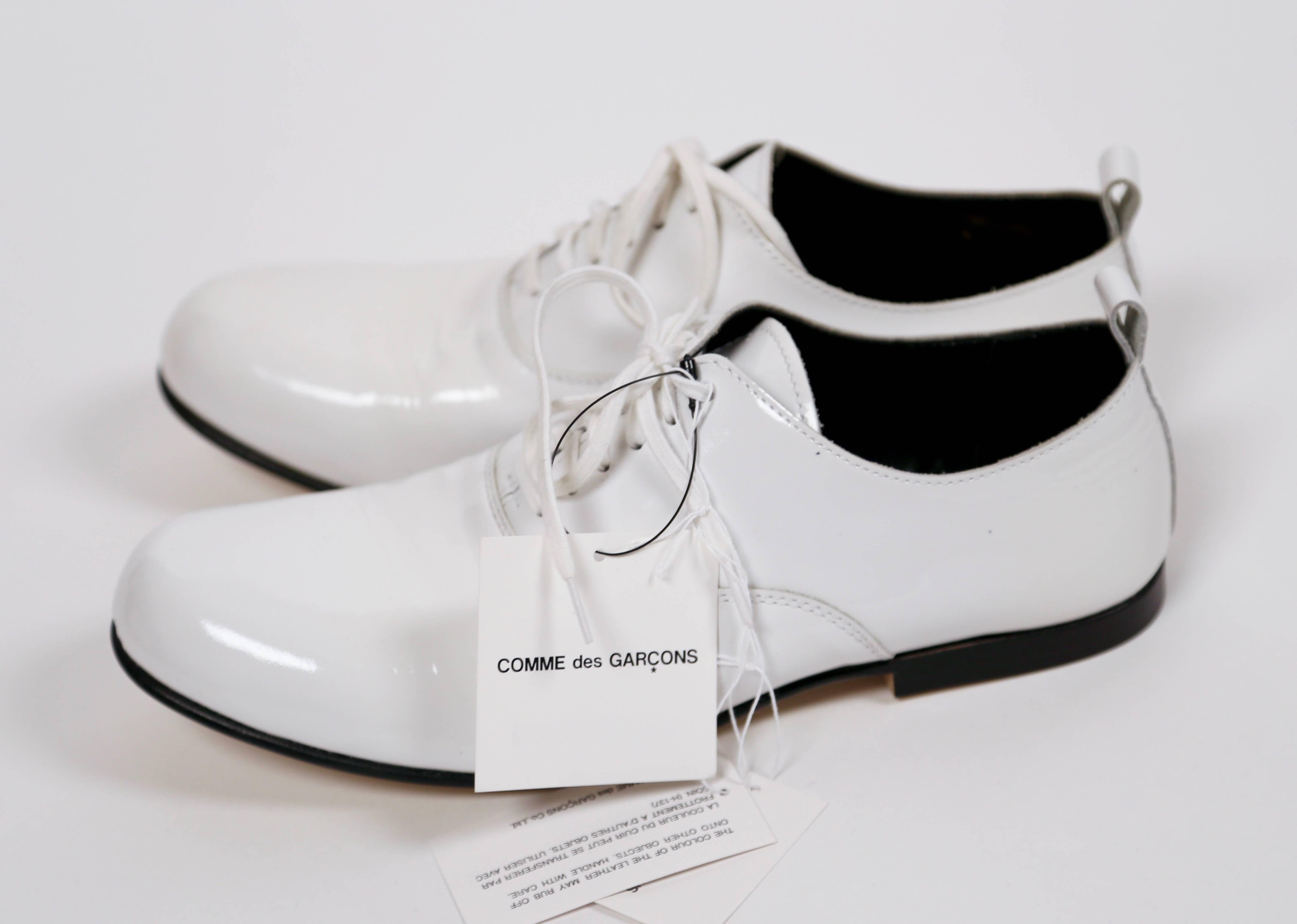 Unworn white patent leather oxfords from Comme Des Garcons dating to the fall 2007-2008 'curiosity' collection. Japanese size 23.5 (about a US 7.5 or Euro 38). Insoles measure approximately: just under 10