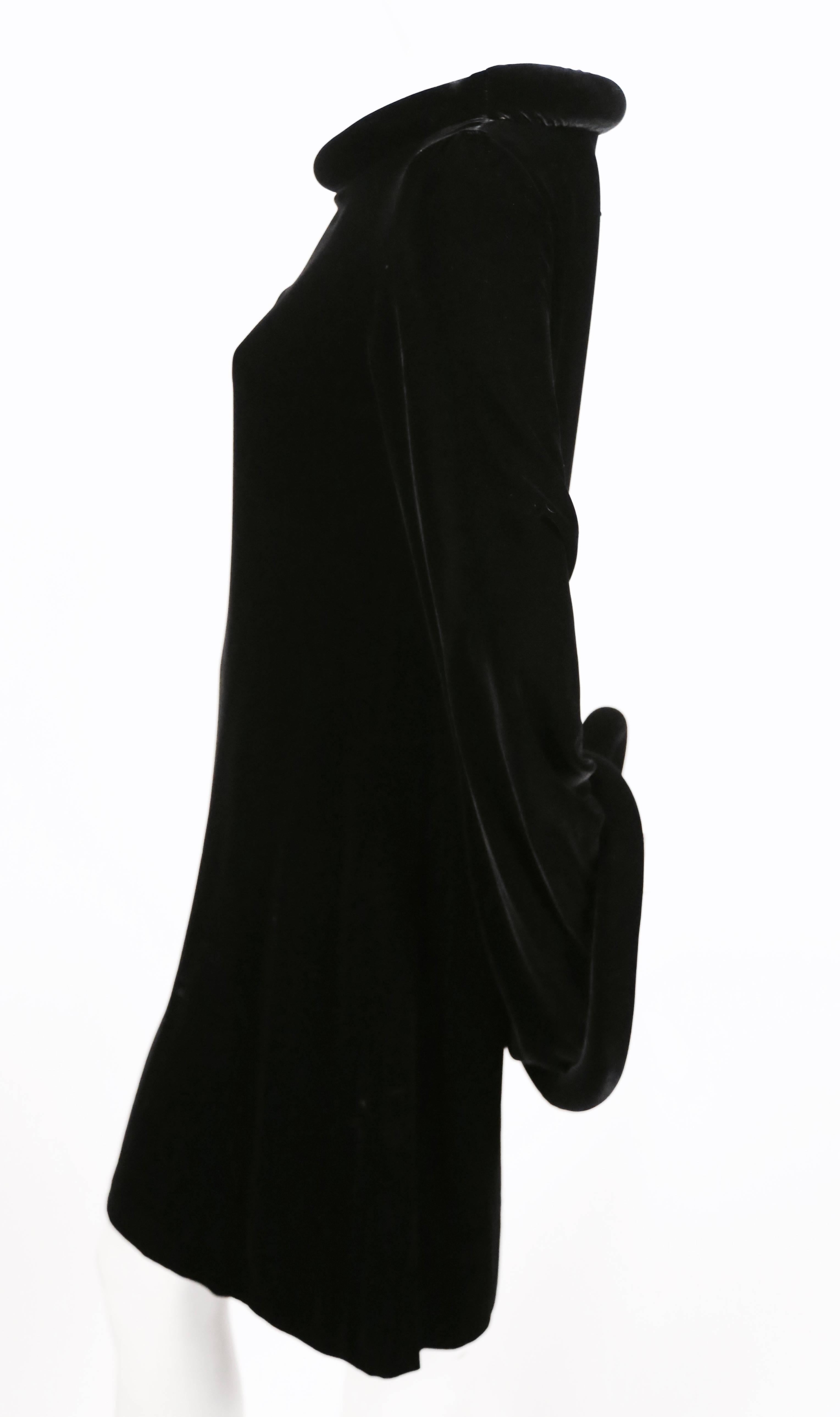 Very rare jet black velvet dress with padded collar and cuffs from Jean Paul Gaultier dating to fall of 1995. Dress is labeled a French size 38. Approximate measurements: shoulder 16