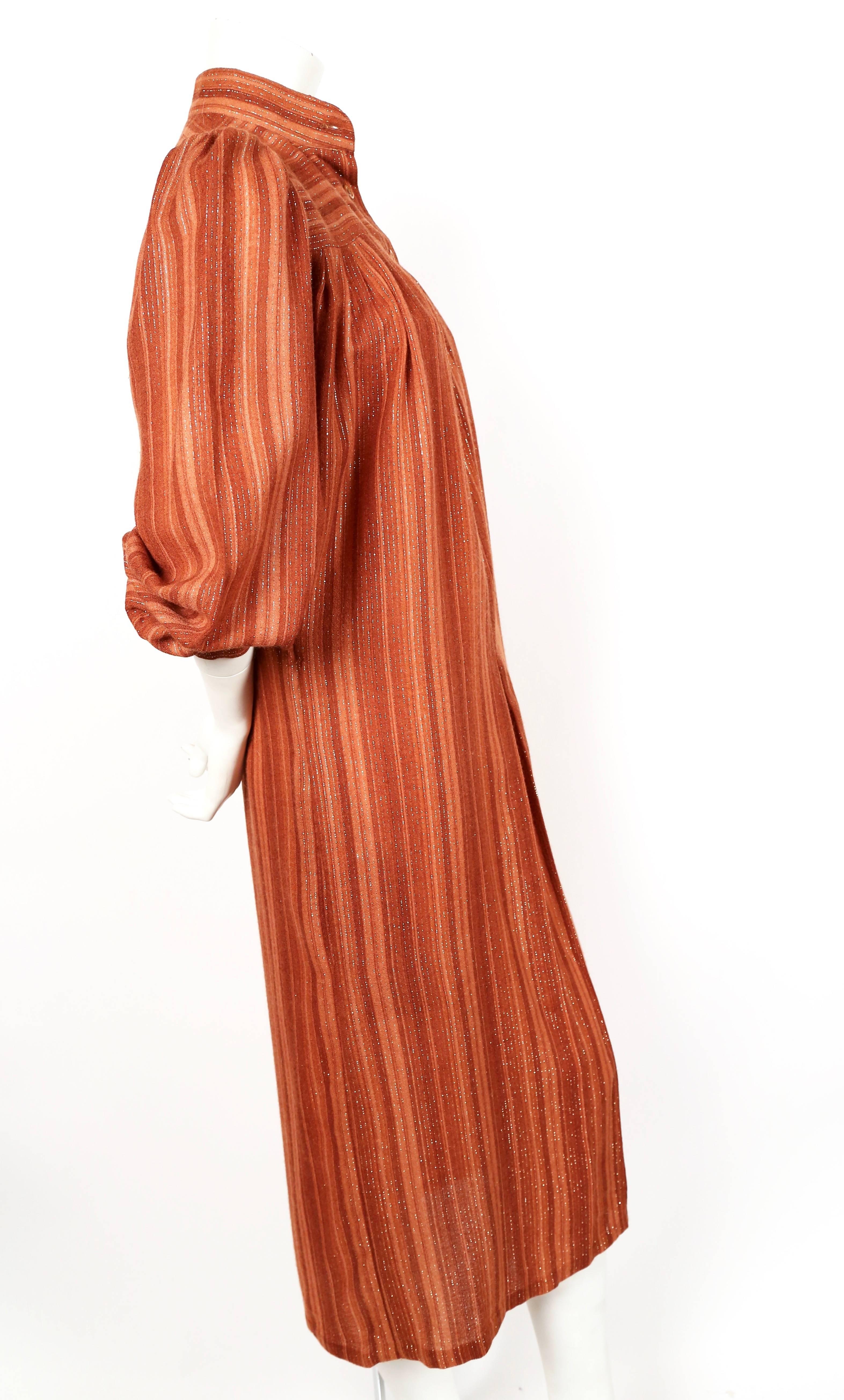 Striped rust dress with lurex designed by Yves Saint Laurent dating to the Opéra Les Ballets Russes collection of 1976. While I couldn't find any specific images of this dress I was able to find pieces made with this fabric. Labeled a French size