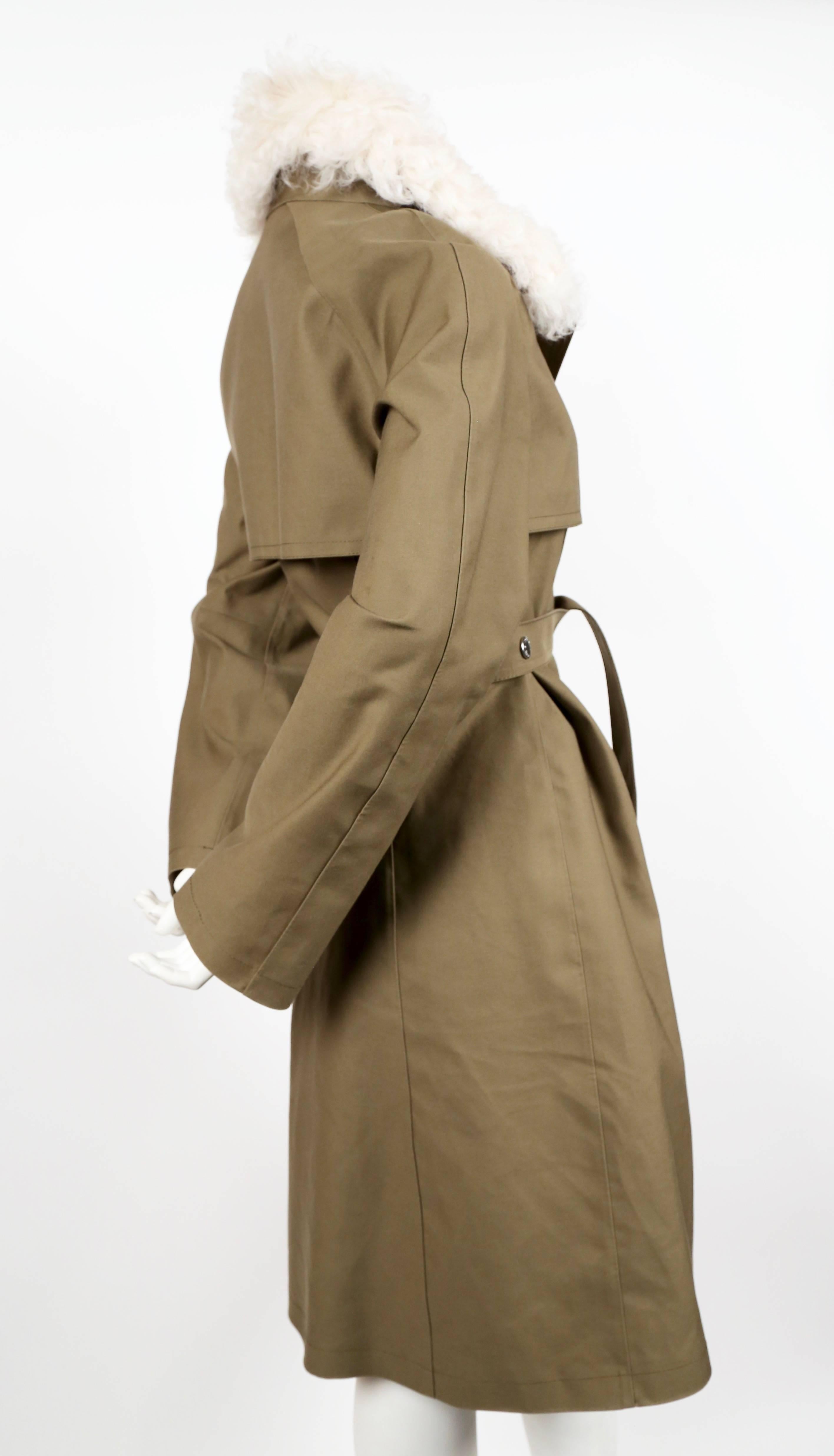 Khaki-green, water-repellent mackintosh trench coat with belt and removable curly lamb fur collar designed by Nicolas Ghesquière for his first collection at Louis Vuitton dating to 2014. French size 38. Approximate measurements: shoulder 16",