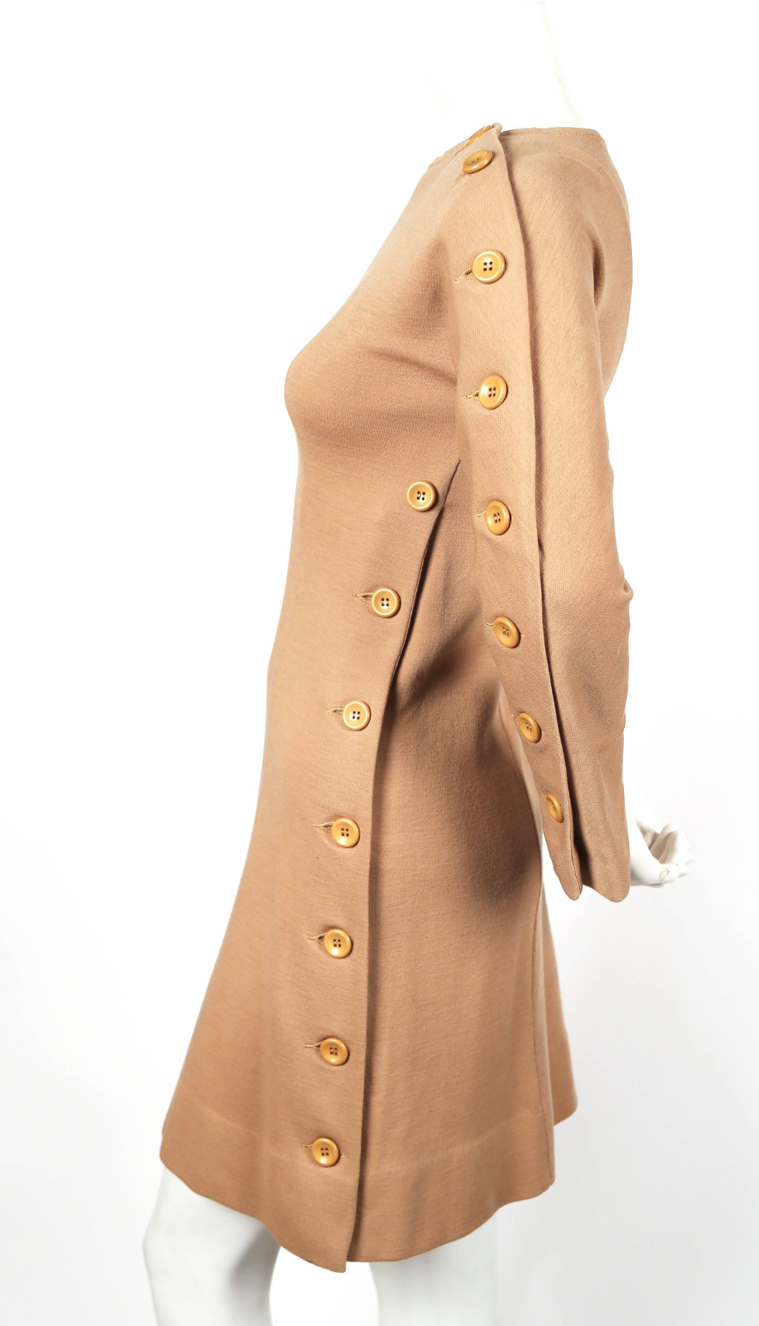 Unusual design from Rudi Gernreich dating to the 1960's. Dress buttons up one side with large buttons. Dress has a great contoured fit with seams that form an A-line shape. Labeled a size 6. Best for a US 2 or 4. Approximate measurements: bust