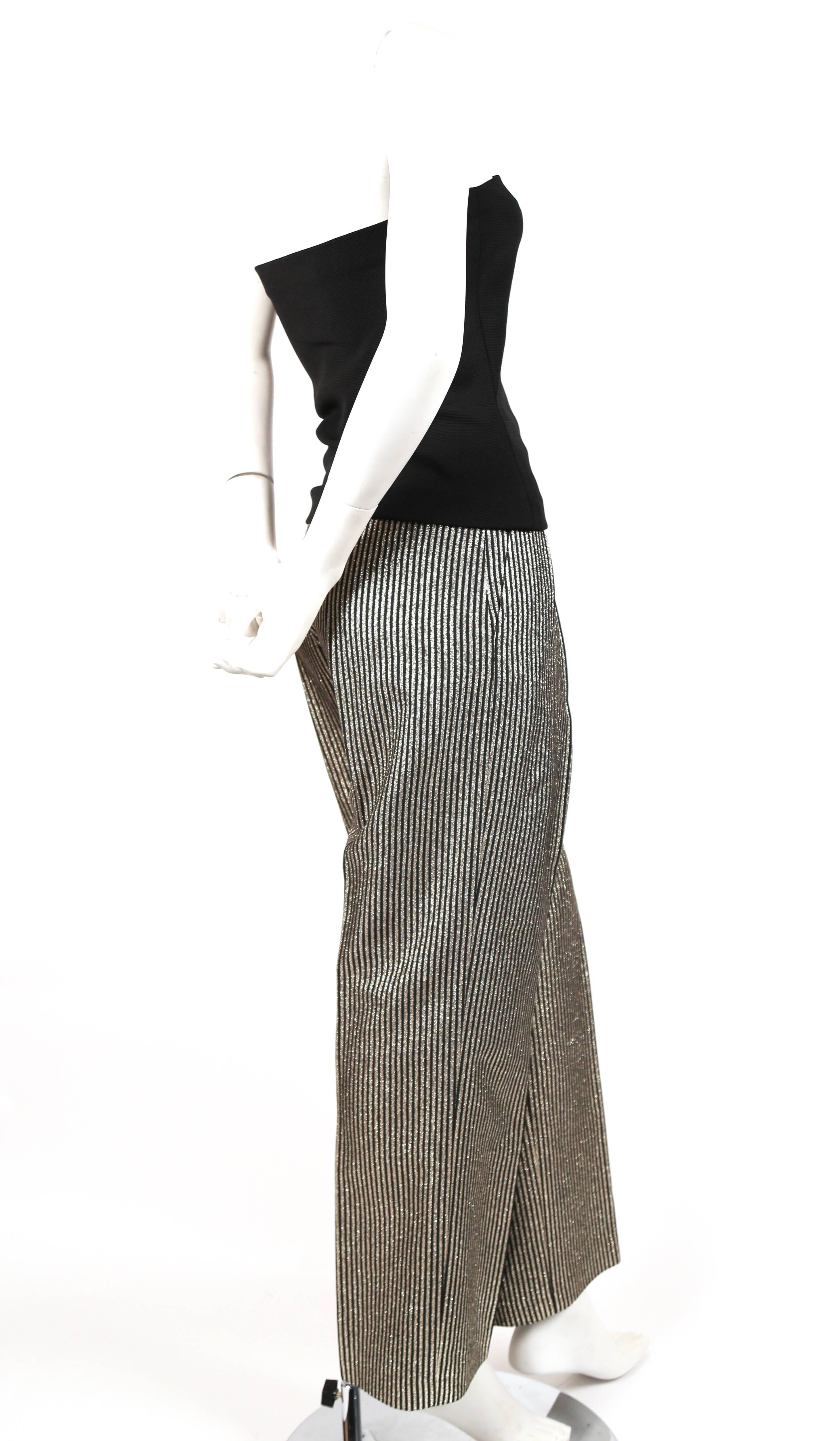 Black strapless top with black and metallic gold wide leg pants from Yves Saint Laurent dating to the late 1970's. Top is labels a French size 36. Sizing is flexible with the top. Pants would best fit a 24-25