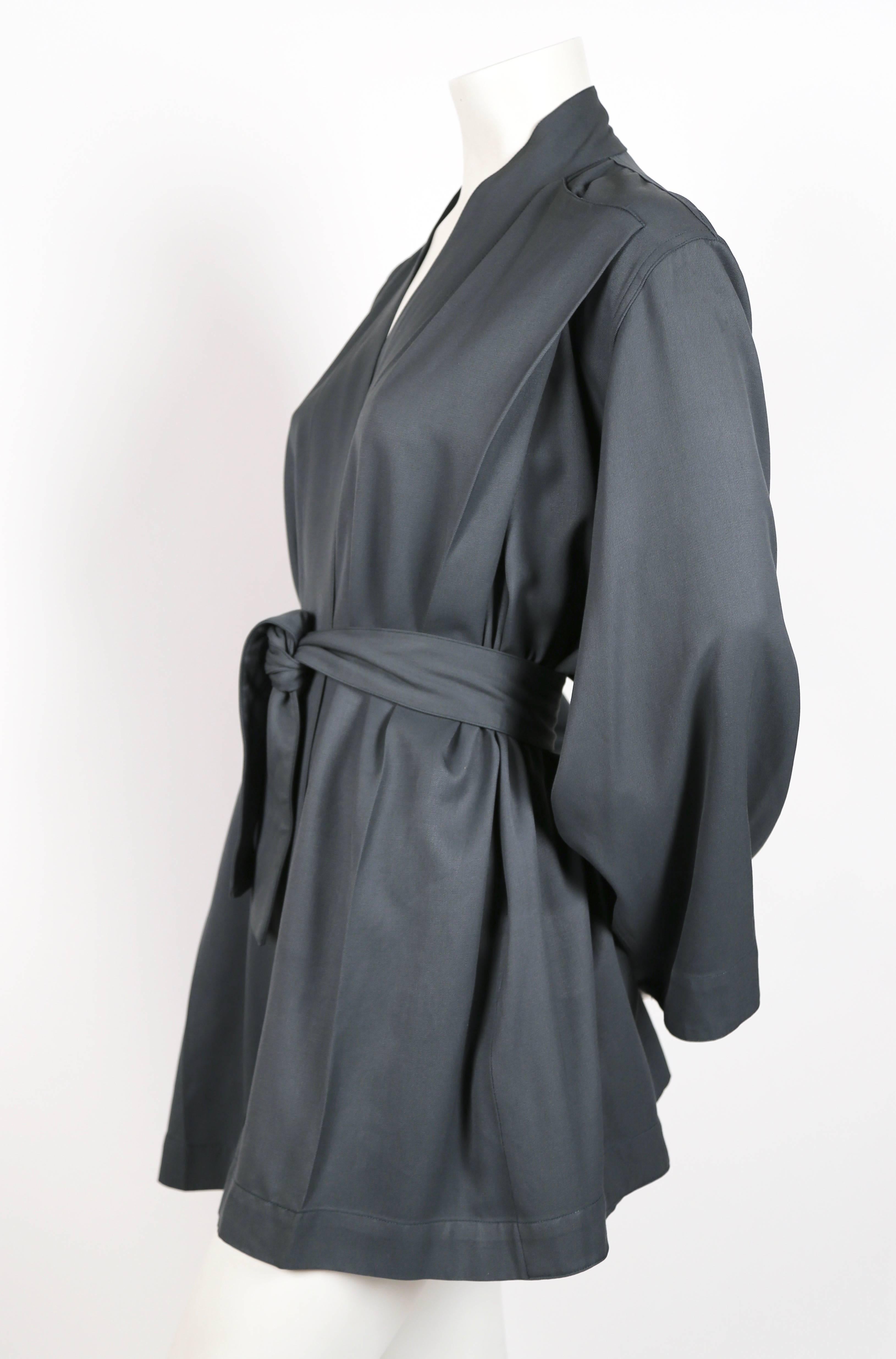 Muted teal wrap gabardine jacket with kimono style sleeves belted waist from Azzedine Alaia dating to the 1980s. There is no size indicated, although this jacket fits a size XS-M due to loose cut. Measures approximately: 18" at drop shoulder,