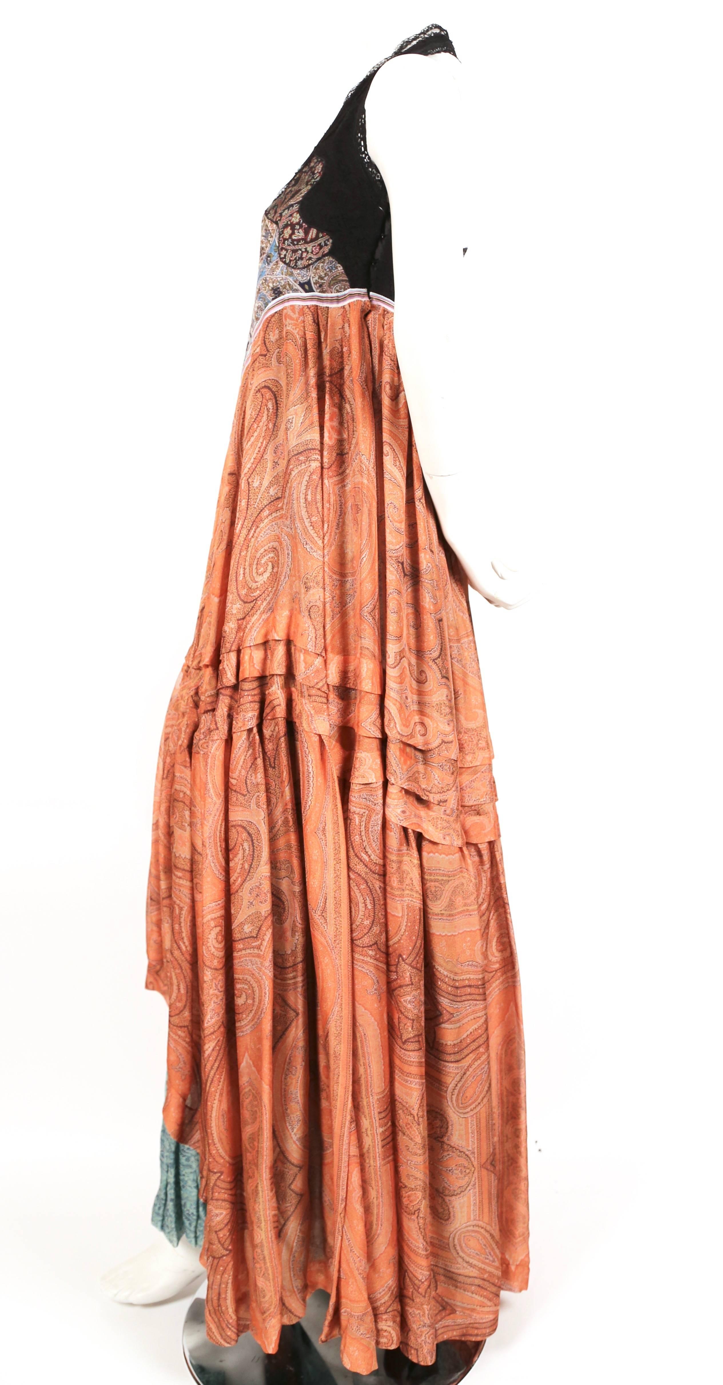 Very rare paisley printed silk dress with striped trim, ruffled hem and lace trim at neck designed by nicolas ghesquiere for Balenciaga dating to spring 2005. French size 36. Approximate measurements: bust 32" and length 46" (at front) and