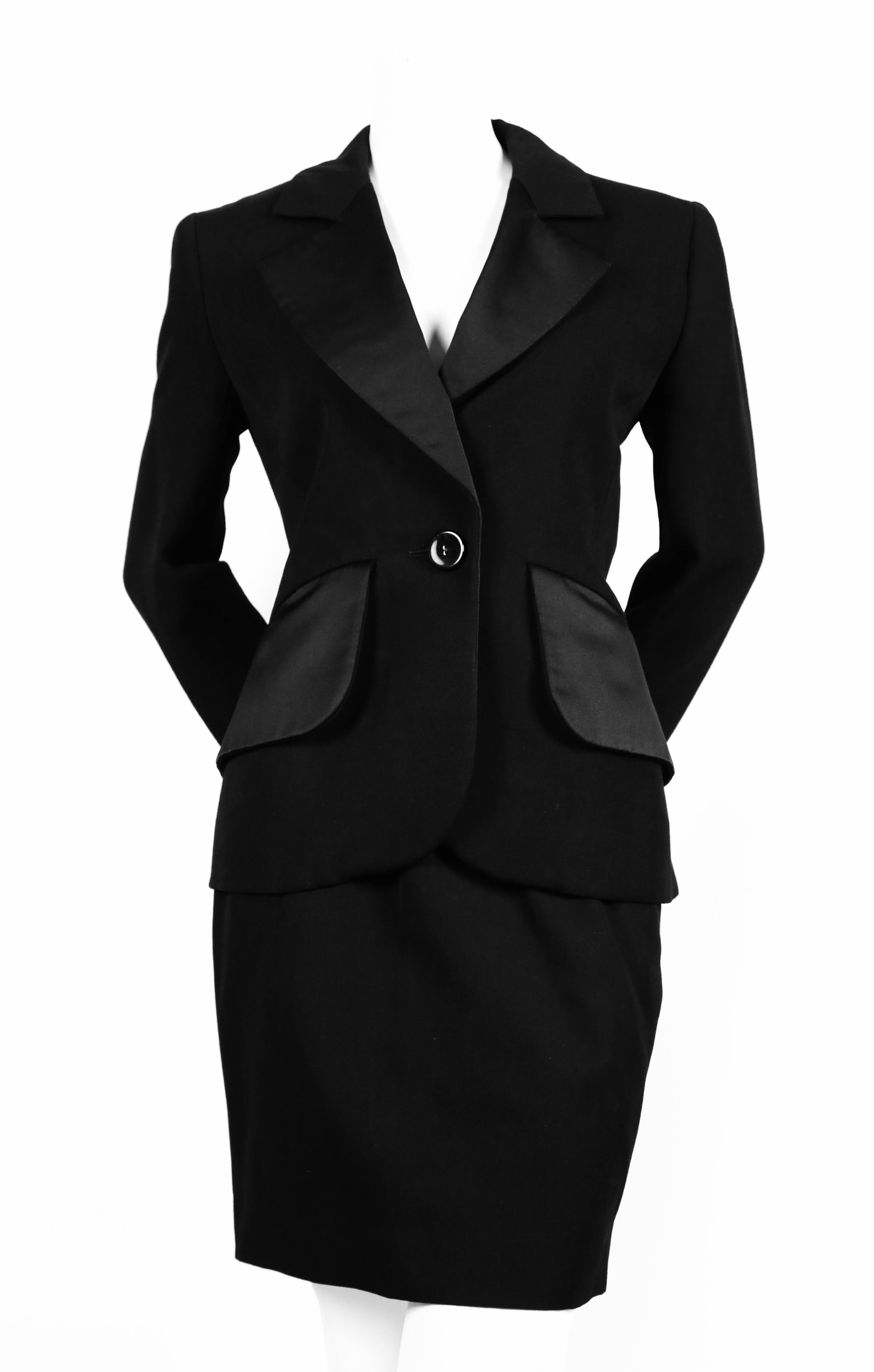 Very rare classic jet black three piece 'le smoking' suit from Yves Saint Laurent dating to the 1980's. Jet black mid weight wool with satin trim. Included is a matching jacket, skirt and pants. Jacket is labeled a French size 36 and skirt/pants a