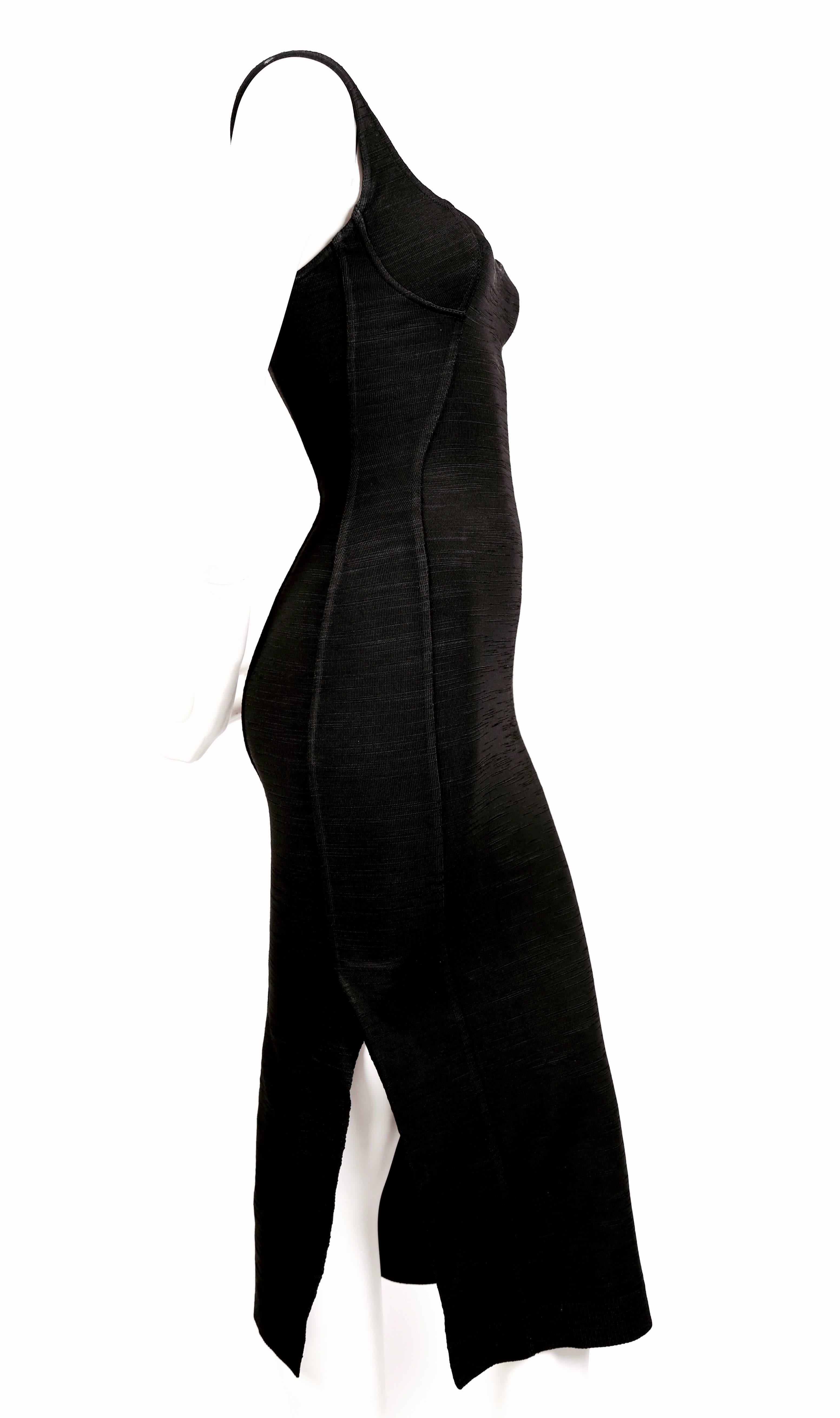 Very rare black long dress with bustier seams and unique vents at sides and back designed by Azzedine Alaia exactly as seen on the spring 1991 runway. Very unique woven textured knit. Labeled a size XS. Best fits a small XS. Approximate measurements