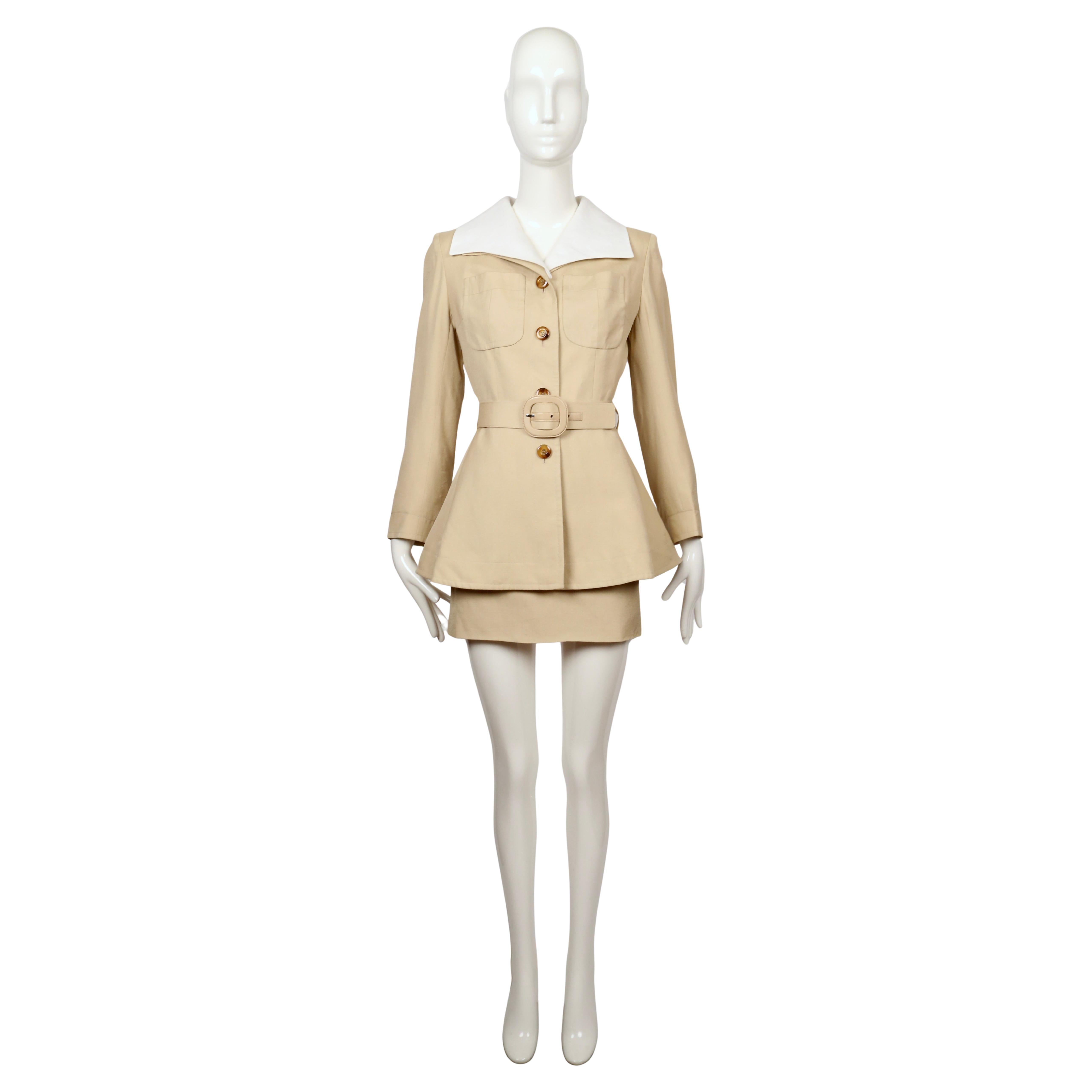 Tailored from a light beige viscose with a smooth hand, this two-piece suit features a fitted jacket cut with a flared peplum. The jacket is detailed with a striking oversized removable white linen collar, chest patch pockets, and tortoiseshell-look