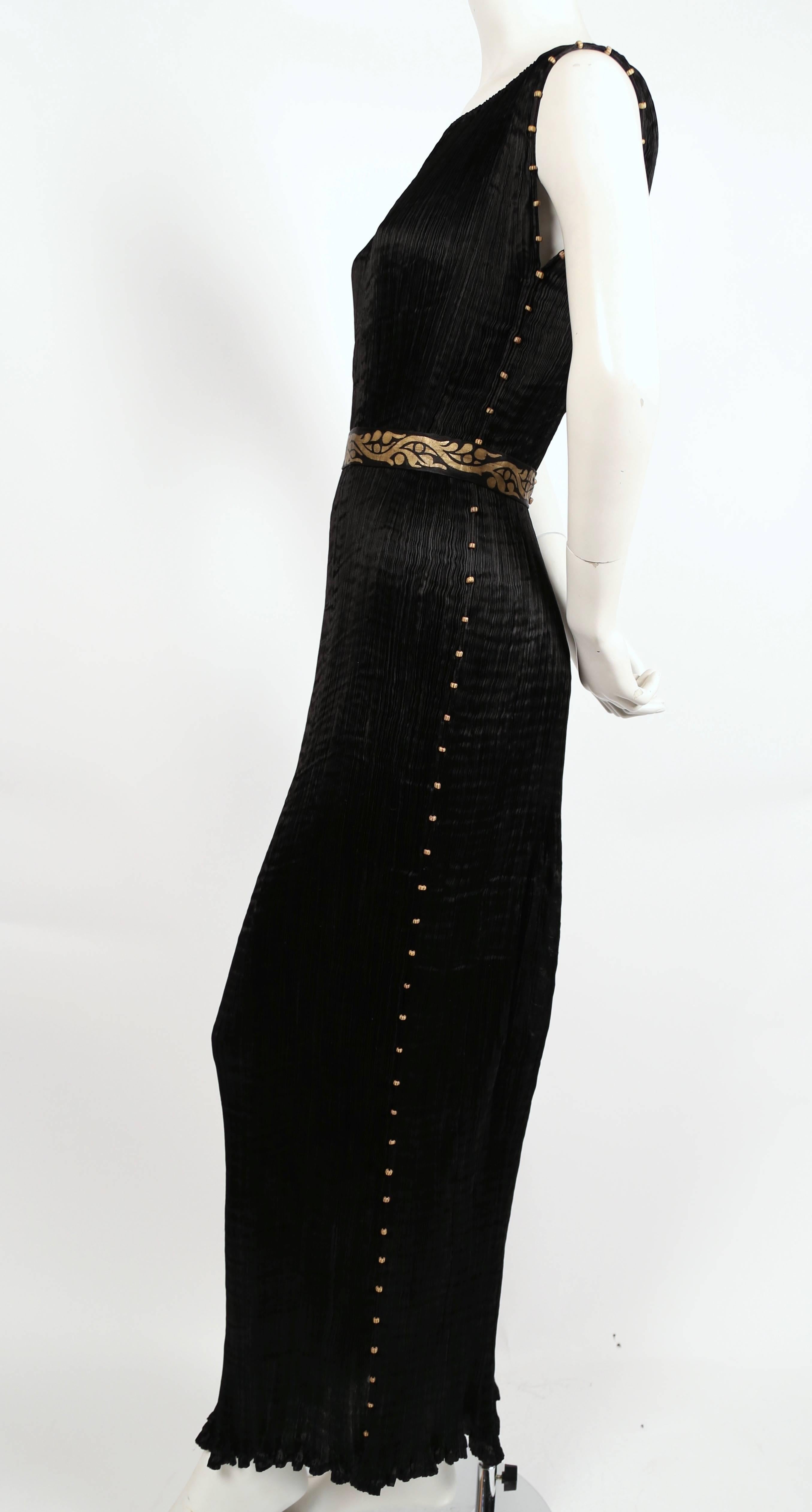 jet black pleated silk 'Delphos' gown with Venetian striped glass beads and stamped gold silk belt from Mariano Fortuny dating to the 1920's. Adjustable drawstring at neckline. Fits a variety of sizes due to the pleated construction. Length is about