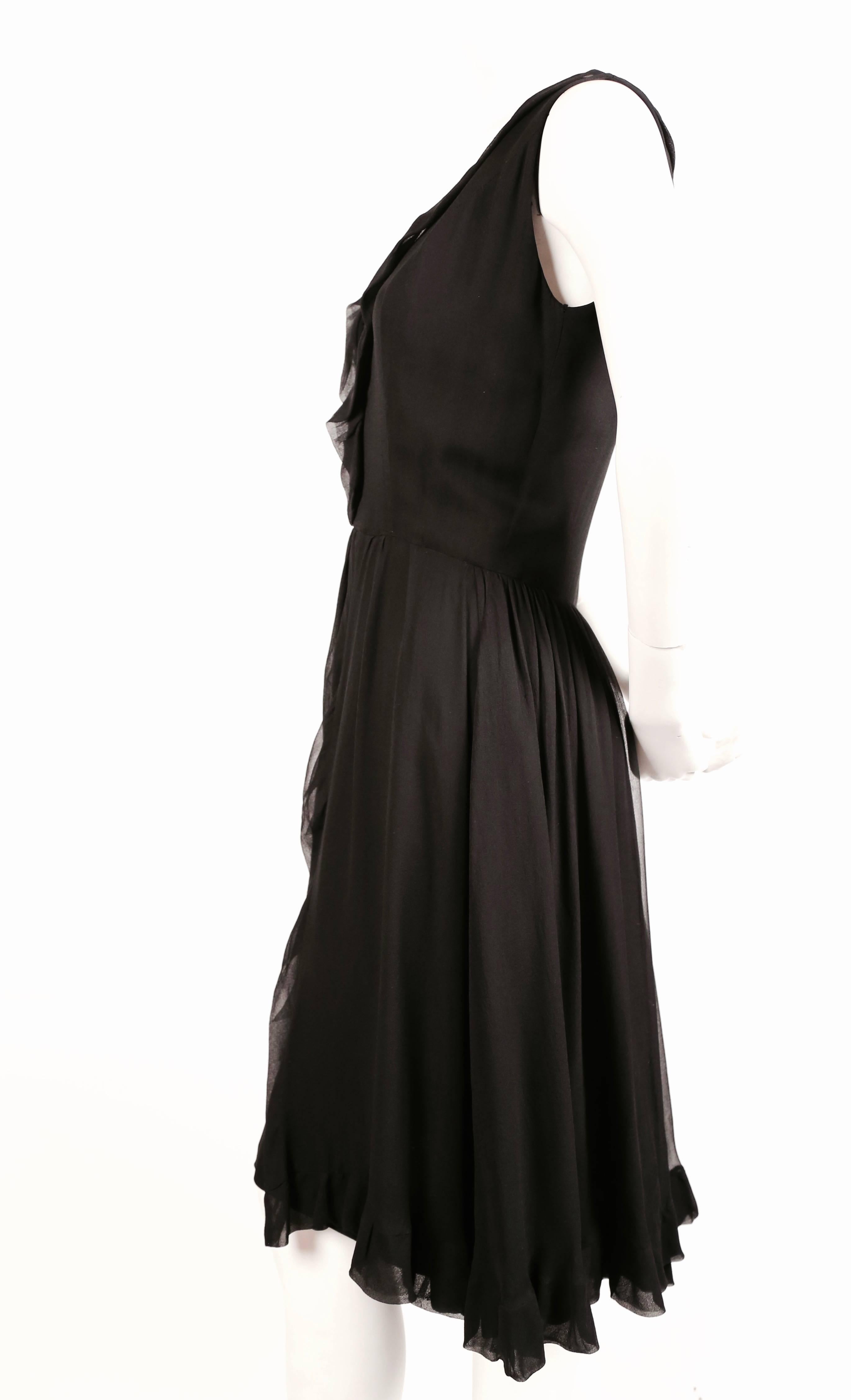 Black silk dress with sheer mousseline overlay designed by Jacques Heim made by Maria carine dating to the 1960's. Fits a US 4 or 6. Approximate measurements: bust 35-36