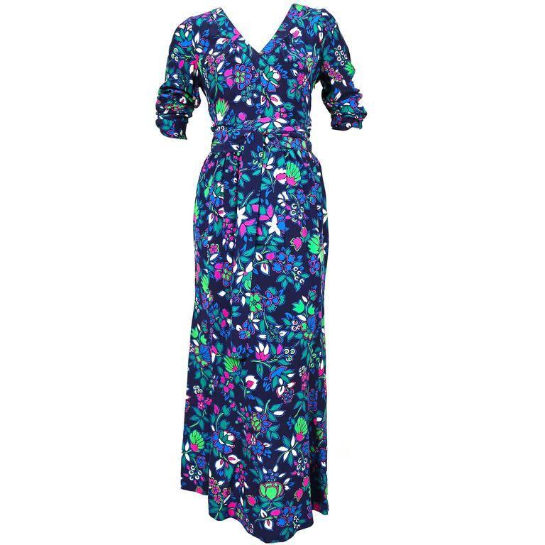 Floral silk dress with long waist tie and v-neckline from Yves Saint Laurent dating to the late 1970's, early 1980's. Labeled a size French size 38 however this better suits a FR 36. Dress measures approximately: bust 34-37