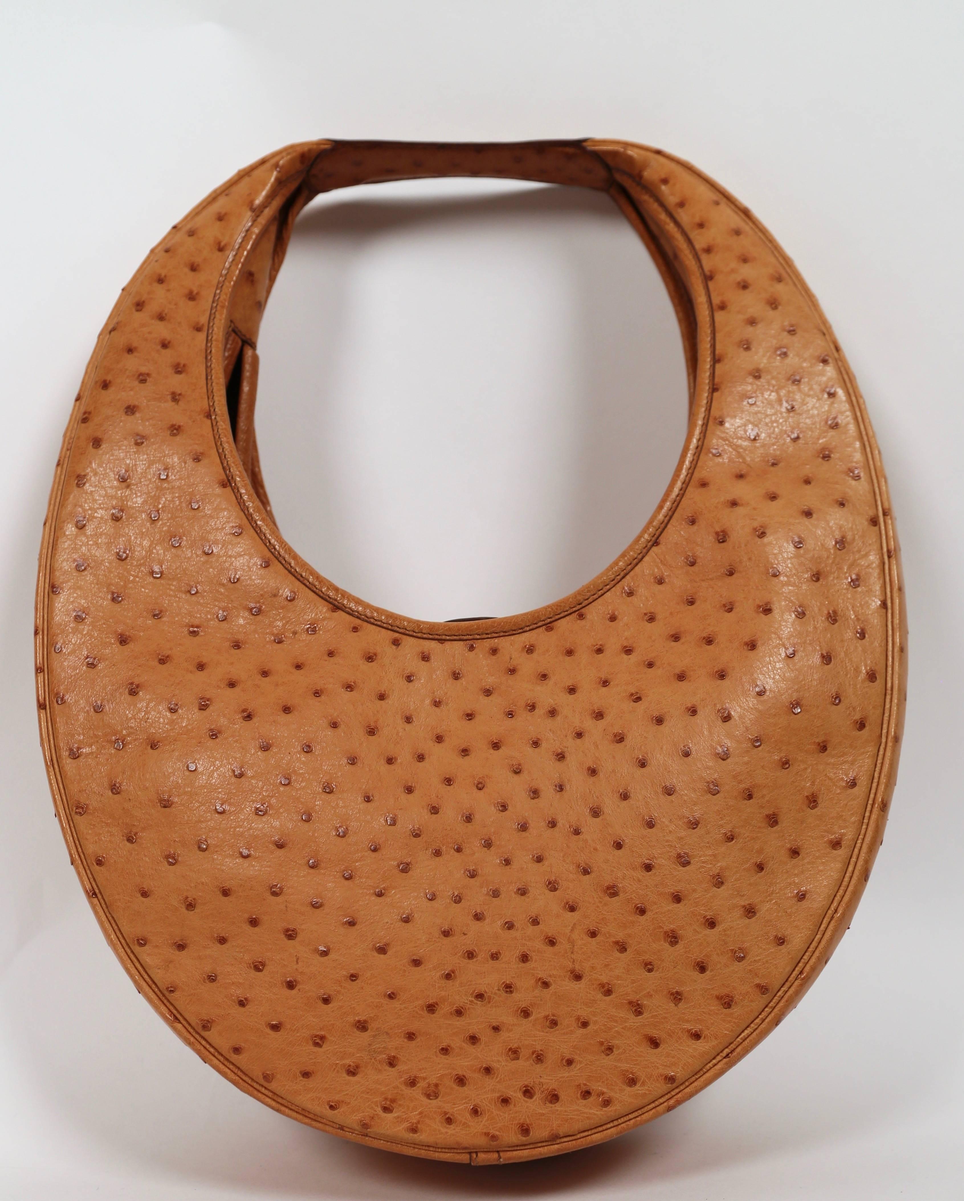 Very rare gold ostrich leather circular 'Folies' bag from Hermes dating to 1989. Measures approximately: 13
