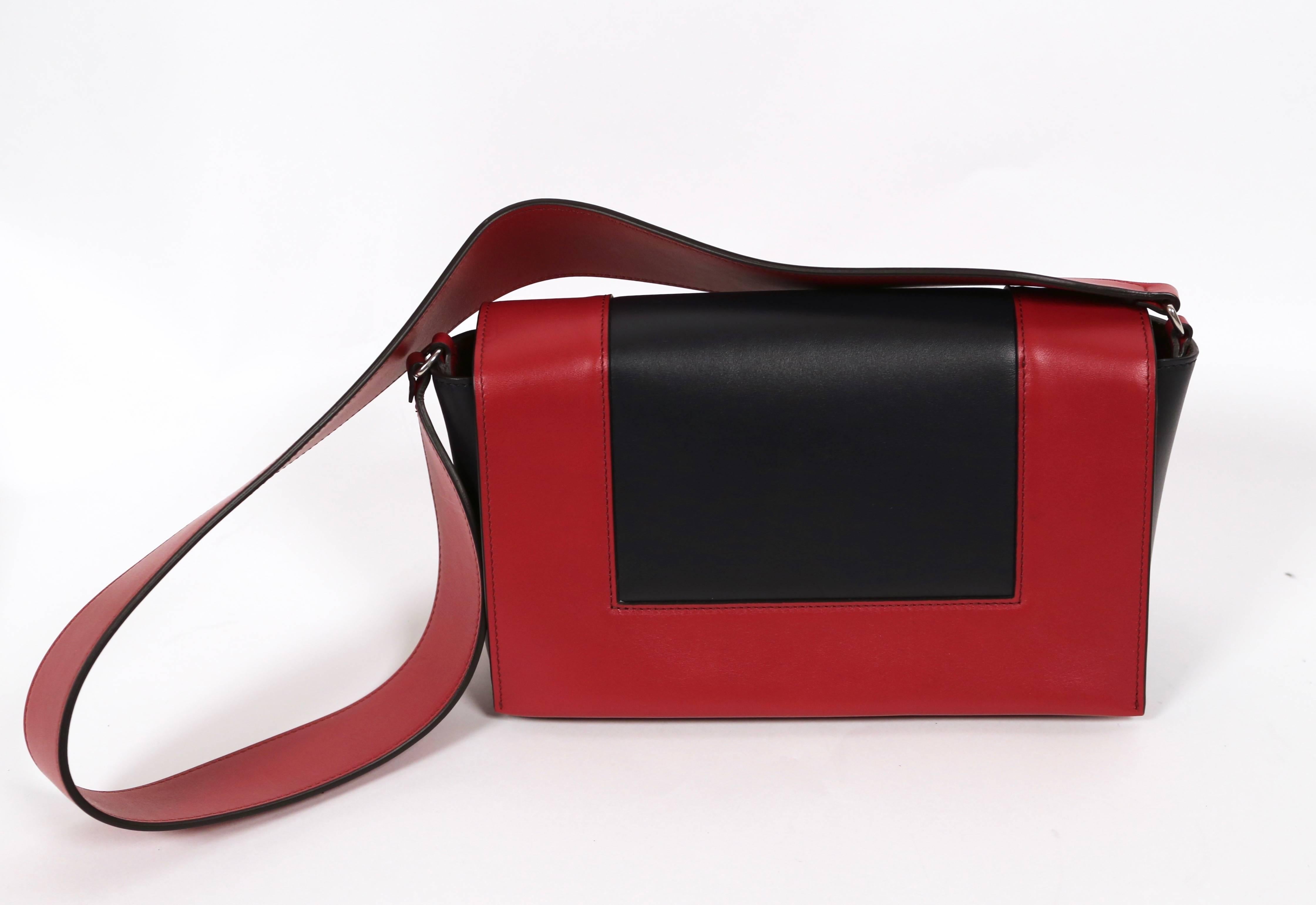 Dark navy blue leather 'frame BAG' with red trim designed by Phoebe Philo for Celine dating to spring of 2017. Measures approximately: 25 X 17 X 8,5 CM (10 X 7 X 3 IN). Strap drop of approximately 15