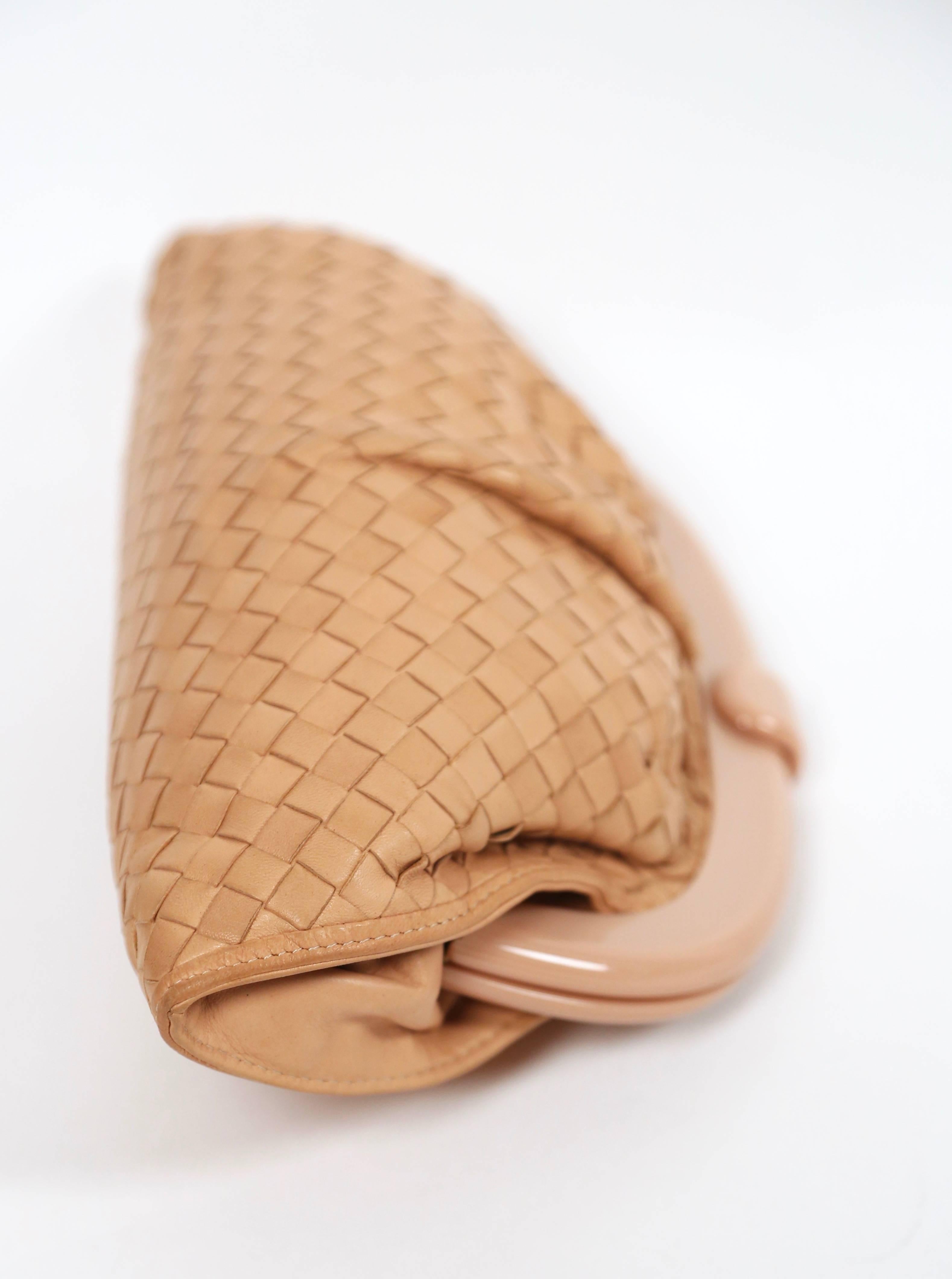 Blush woven leather clutch with lucite frame designed by Bottega Veneta dating to the 1980's. Approximate measurements: 11.5