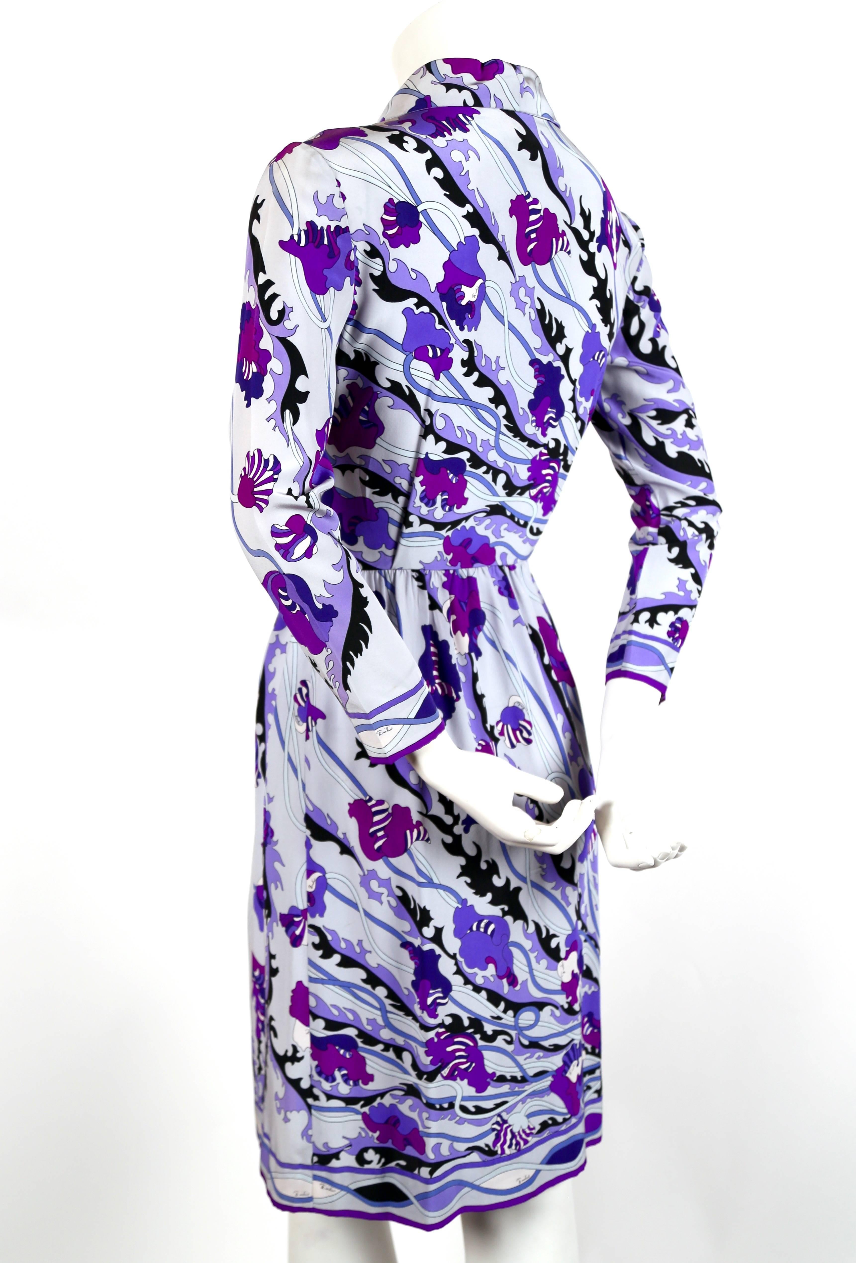 Vibrant EMILIO PUCCI floral printed silk dress dating to the 1960's. Beautiful color scheme of blues and purples with black accents. Snap closure at front. Fits a US 2. Bust measures approximately 34