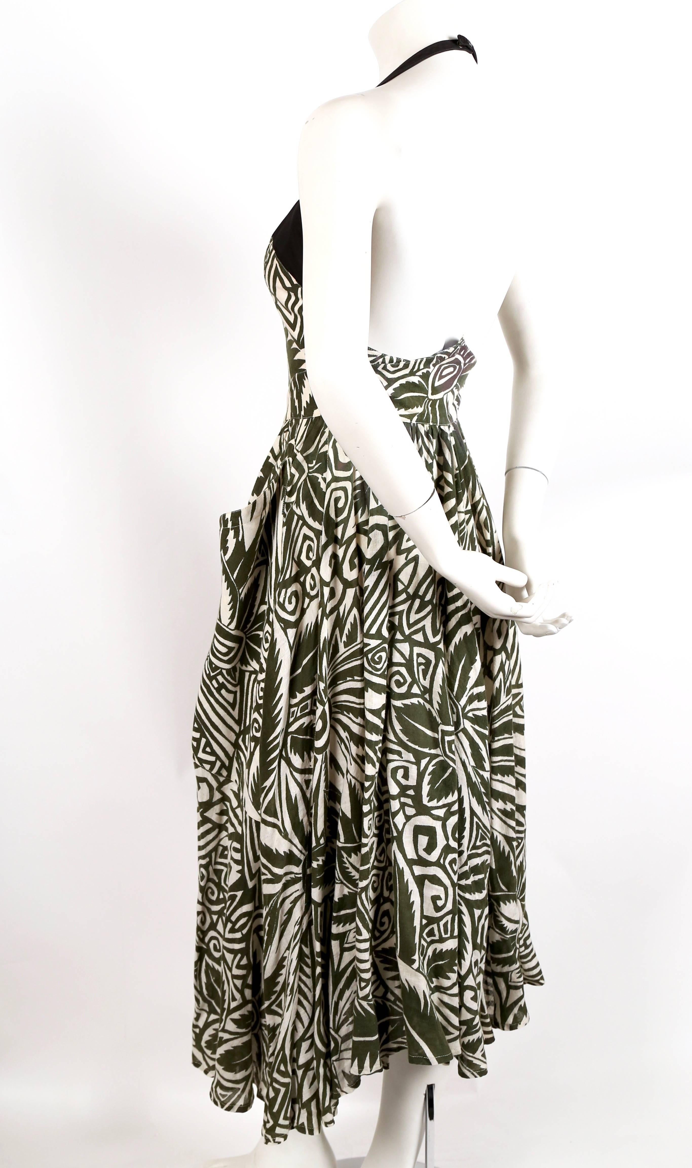 Green floral printed cotton dress with black halter neck, large wrap around patch pockets and snap front closure from Thierry Mugler dating to the 1990's. Hem has an interesting asymmetrical shape with the sides falling longer than the front and