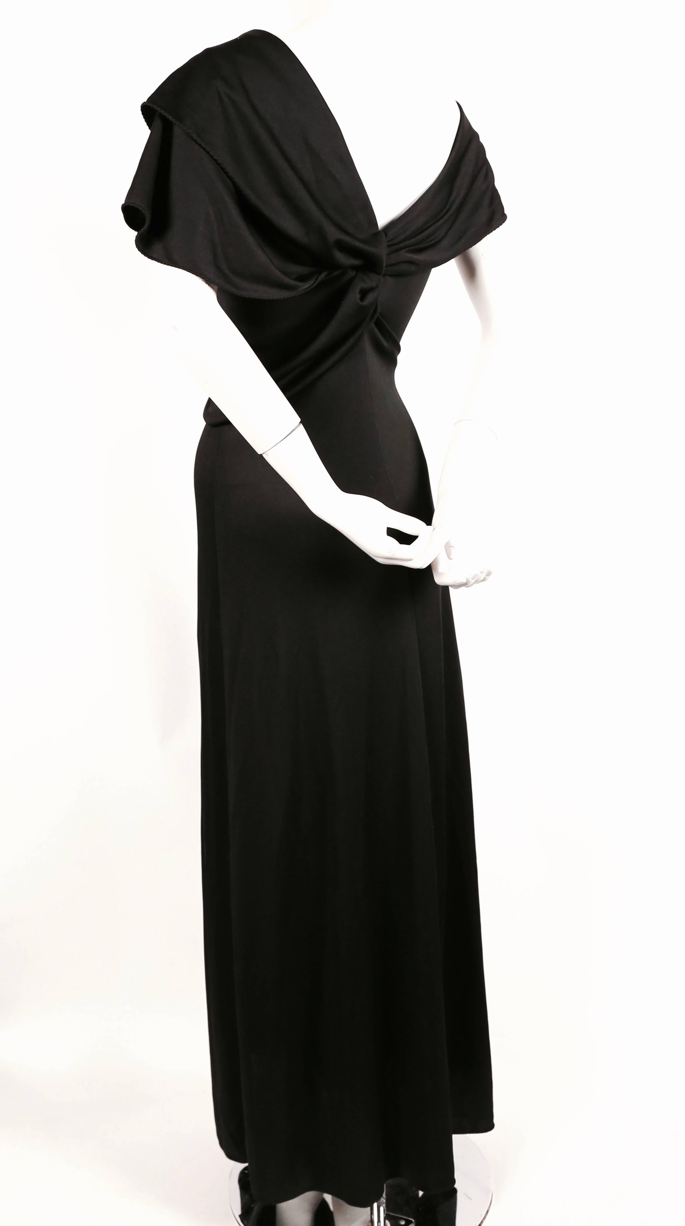 Jet black jersey dress with draped neckline and 'lettuce-edge' hems designed by Stephen Burrows dating to the 1970's. Fits a US 4-8. Measurements are as follows: bust 32