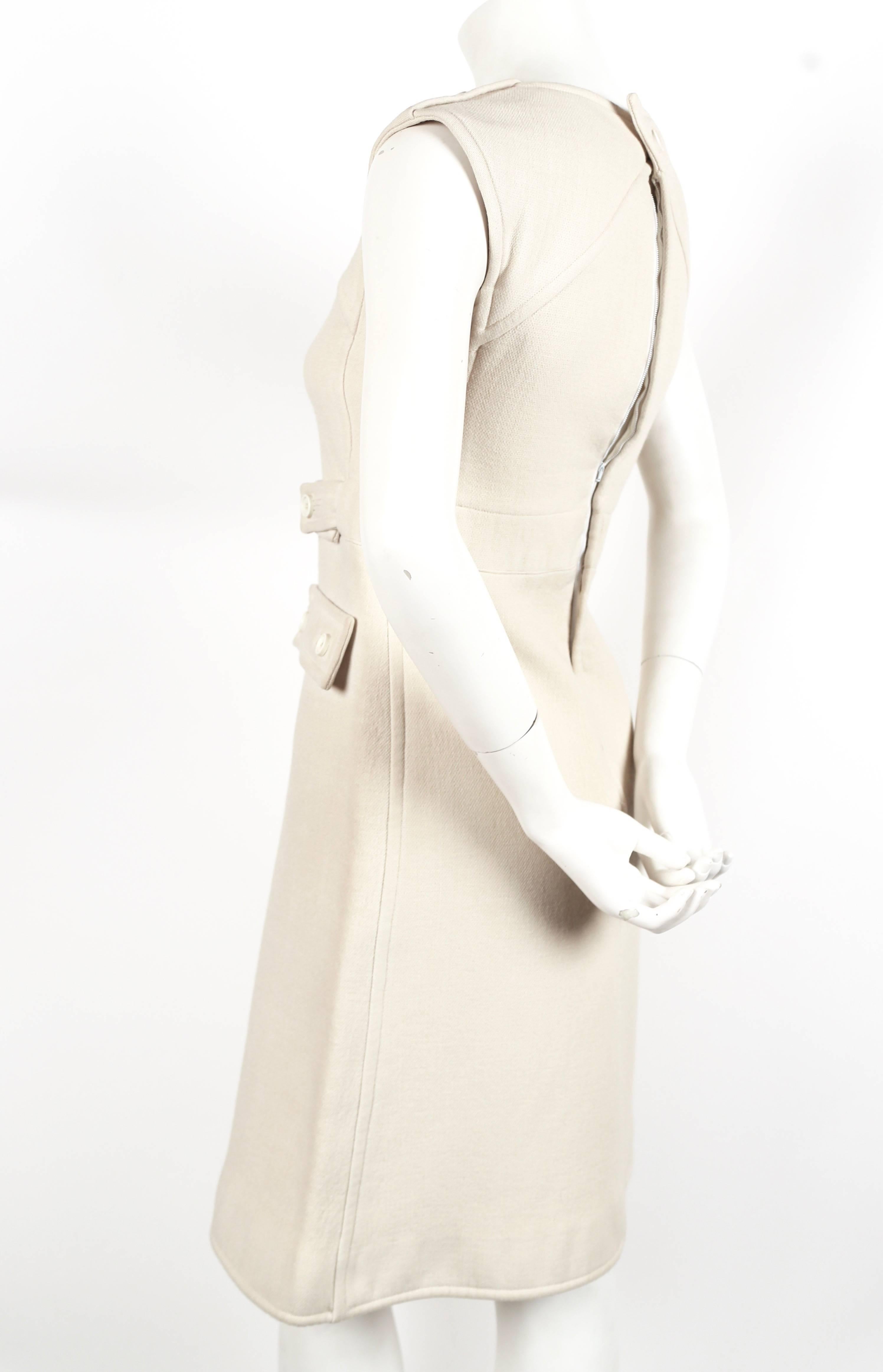 Off-white haute couture dress from Courreges dating to the 1960's. Dress best fits a size 0 or 2. Approximate measurements are as follows: bust 31-32", high waist 30", hips 36" and length is 38". Fully lined. Back closure with
