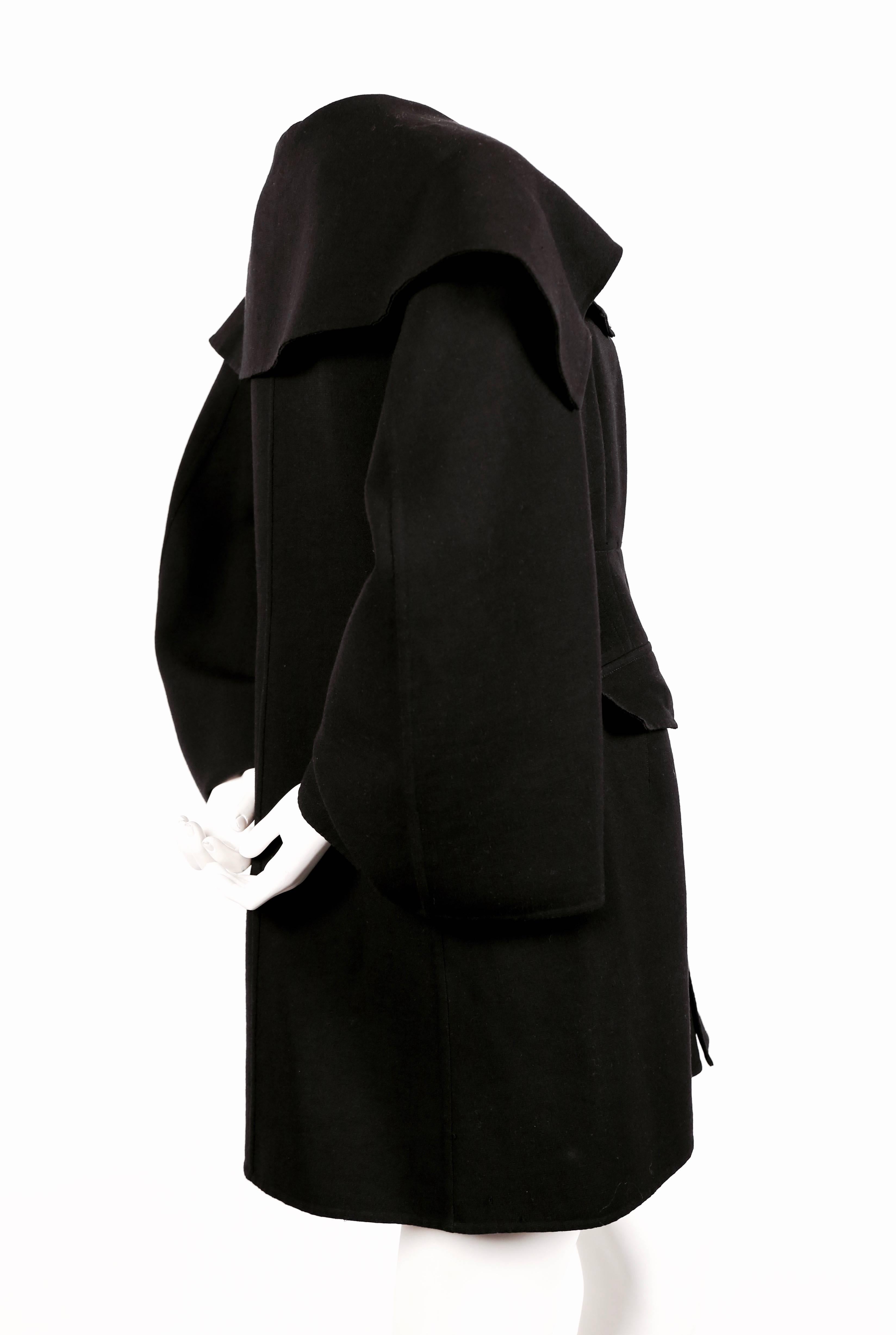 Black wool coat with exaggerated collar designed by Yohji Yamamoto dating to the 1980's. Size 'M'. Has an very interesting oversized fit. Approximate measurements: drop shoulder 21