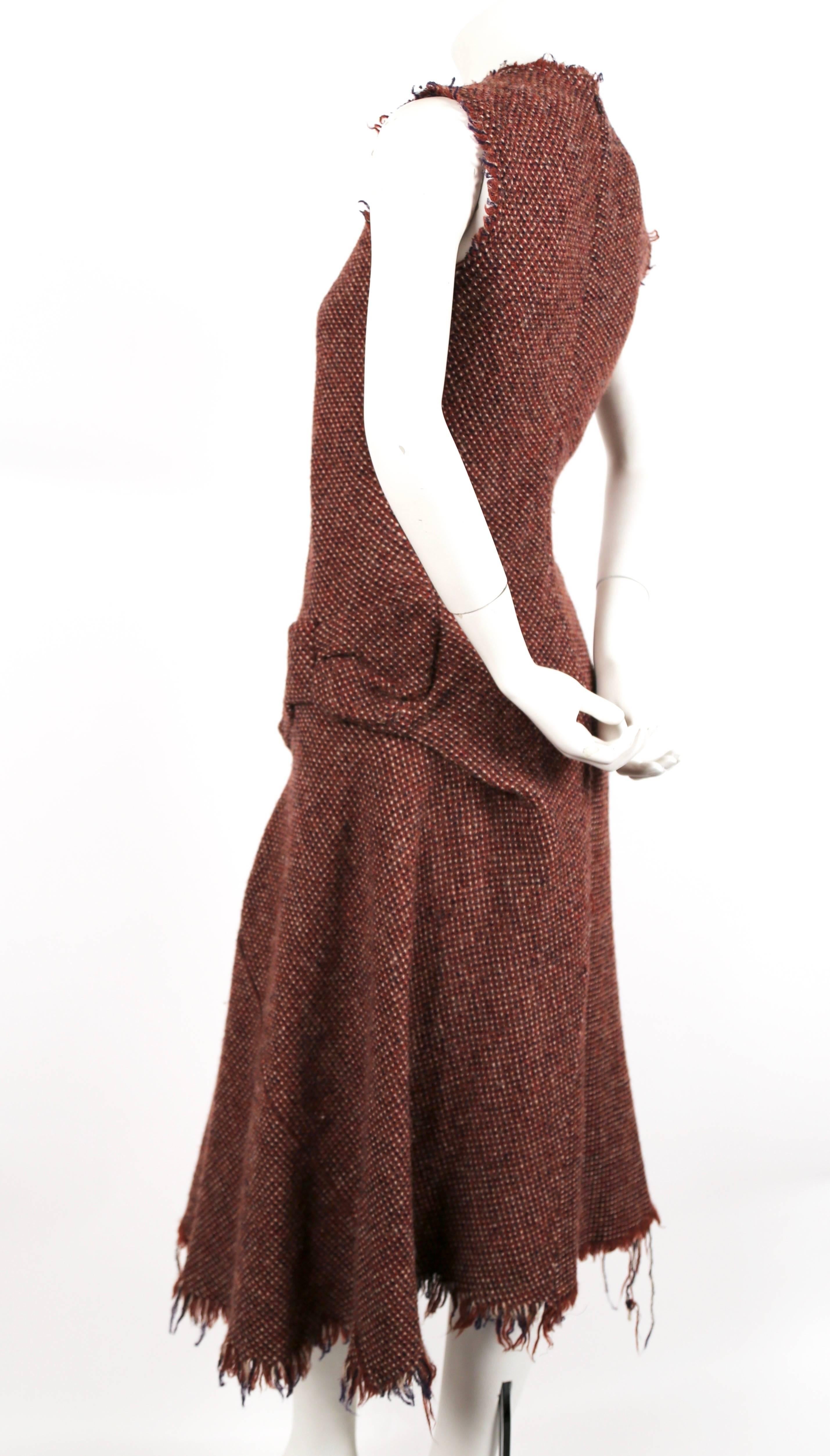 Fuzzy tweed wool dress with uniquely seamed 'bow' at left hip and frayed hemline designed by Junya Watanabe for Comme Des Garcons as seen on the fall 2003 runway. Size 'S'. Approximate measurements: shoulder 14