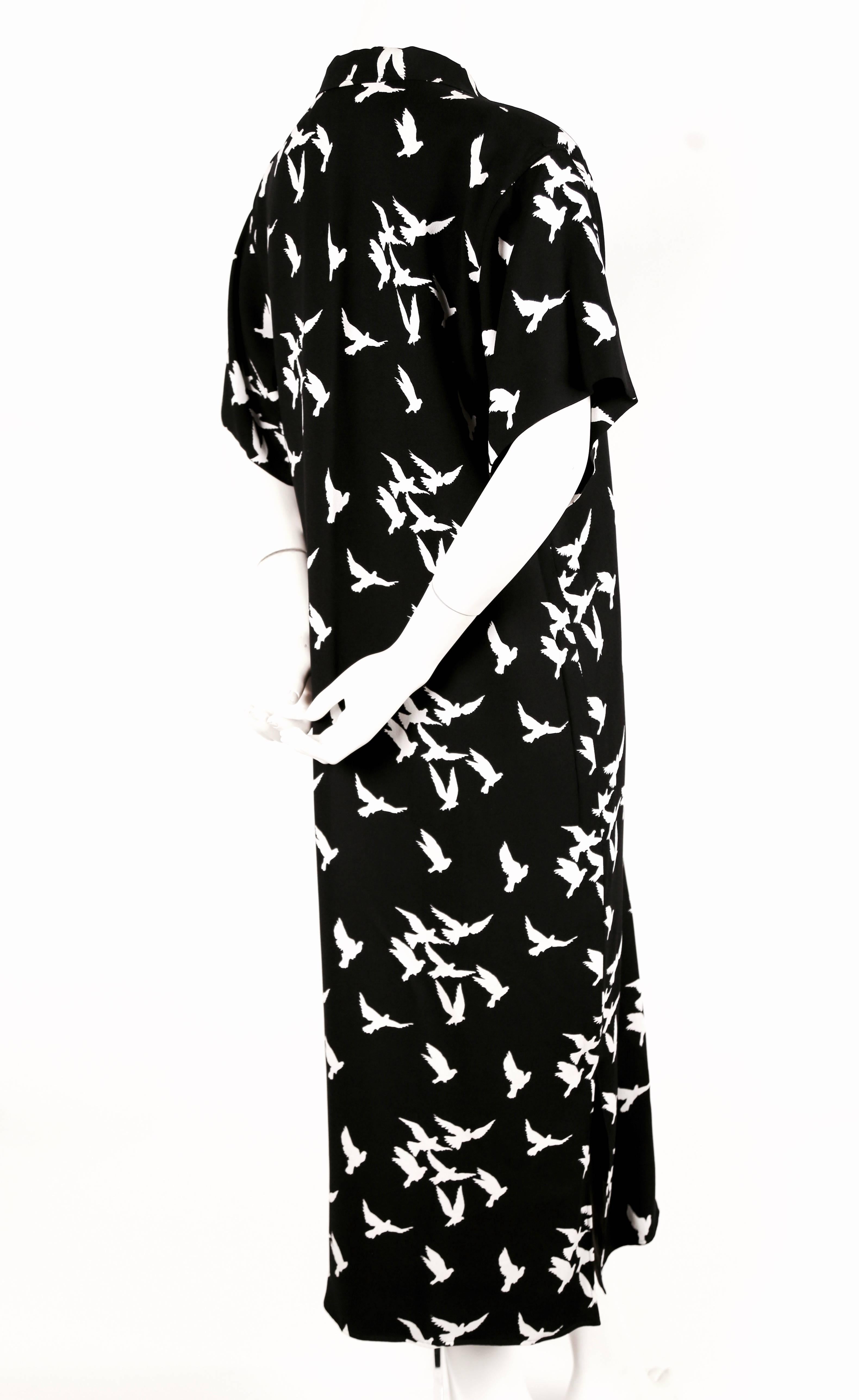 Jet black crepe printed dress with white birds from Yves Saint Laurent dating to 1978. No size is indicated however this dress best fits a US 4 to 8. Approximate measurements: shoulder 18", bust 40", hips 41", length 50". Slits
