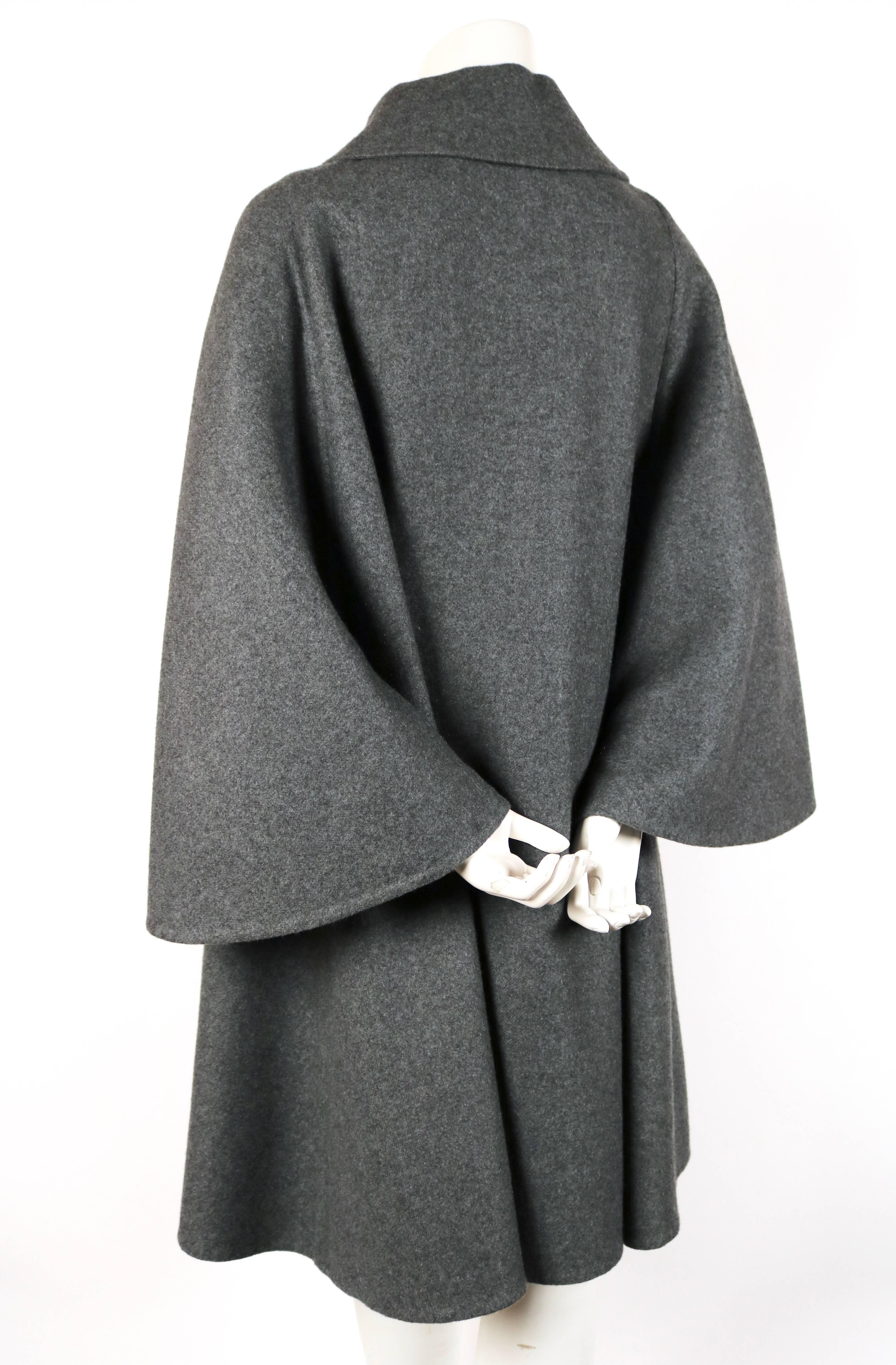 Unworn charcoal grey double faced cashmere cape coat from Hermes dating to fall of 2012. French size 36 however this may fit various sizes due to oversized cut. Approximate measurements: bust 48