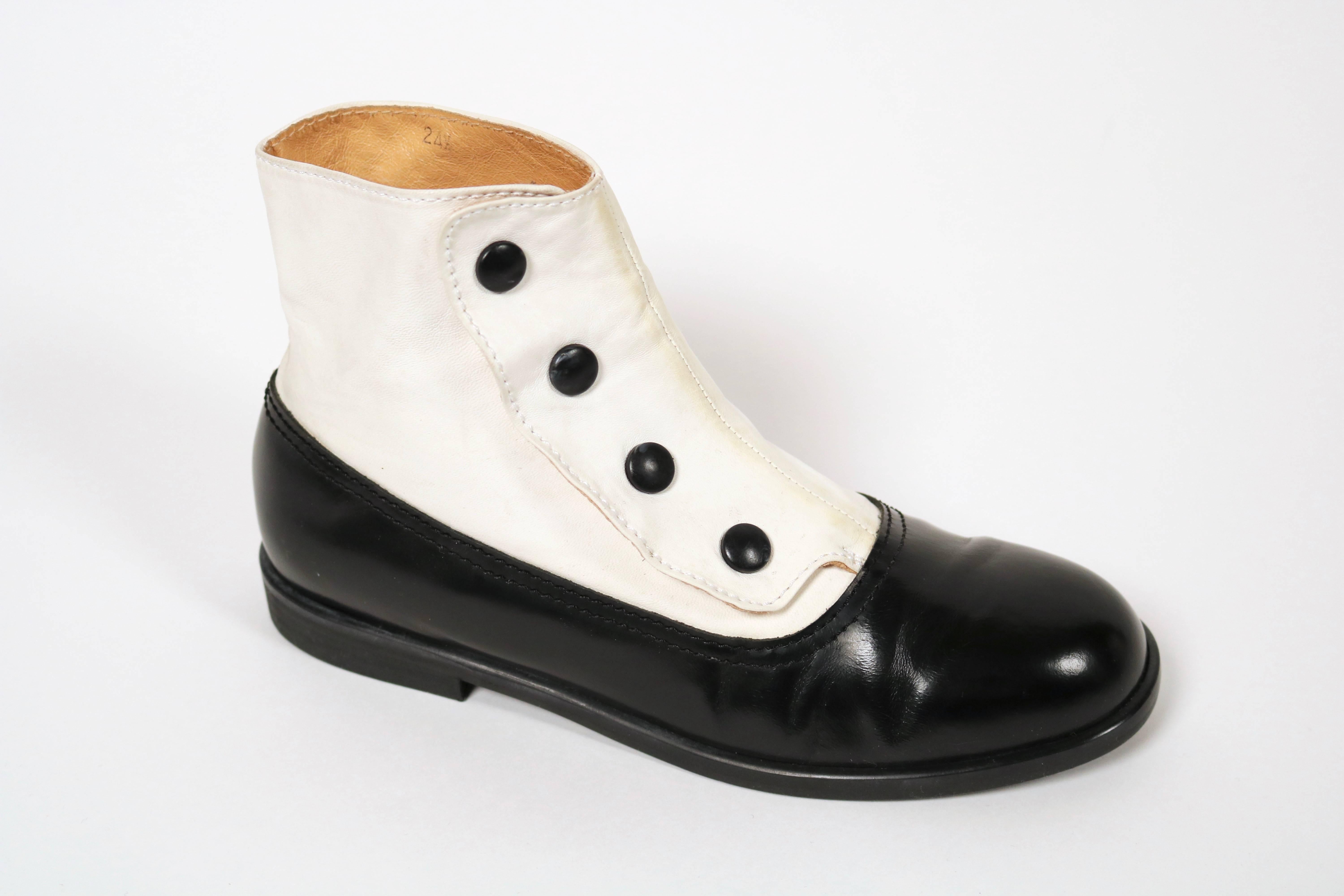 Very unusual black leather booties with attached white leather spats designed by Yohji Yamamoto dating to the 1980's. Labeled a size 'L' which best fits a US 8 or 8.5. Insoles are approximately 24.5 cm long and just over 8 cm wide. Snap closure.