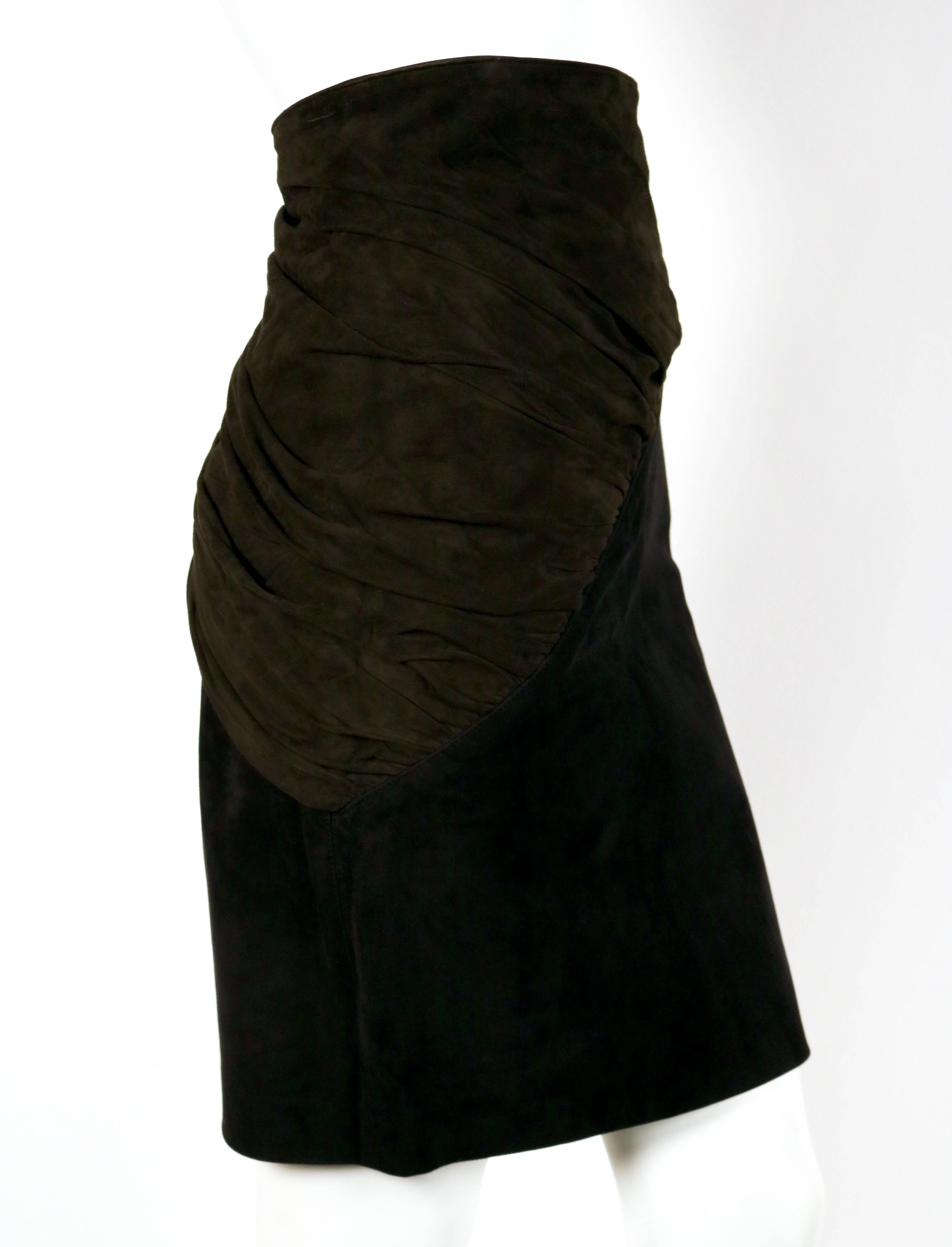 Jjet black suede skirt with olive suede ruched panel and side buckle from Azzedine Alaia dating to the early 1990's. Skirt best fits a size 2 or 4. Approximate measurements: waist 24-25